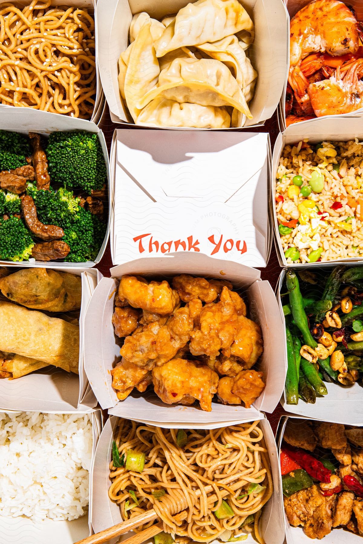 A bunch of chinese food in takeout boxes