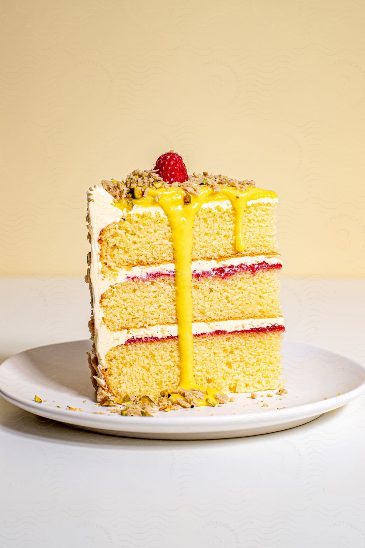 Slice of a cake on a white plate with a strawberry on top