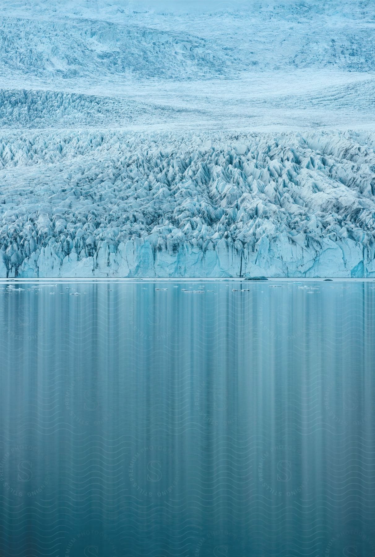 In the Arctic, a large iceberg is in the middle of the sea.