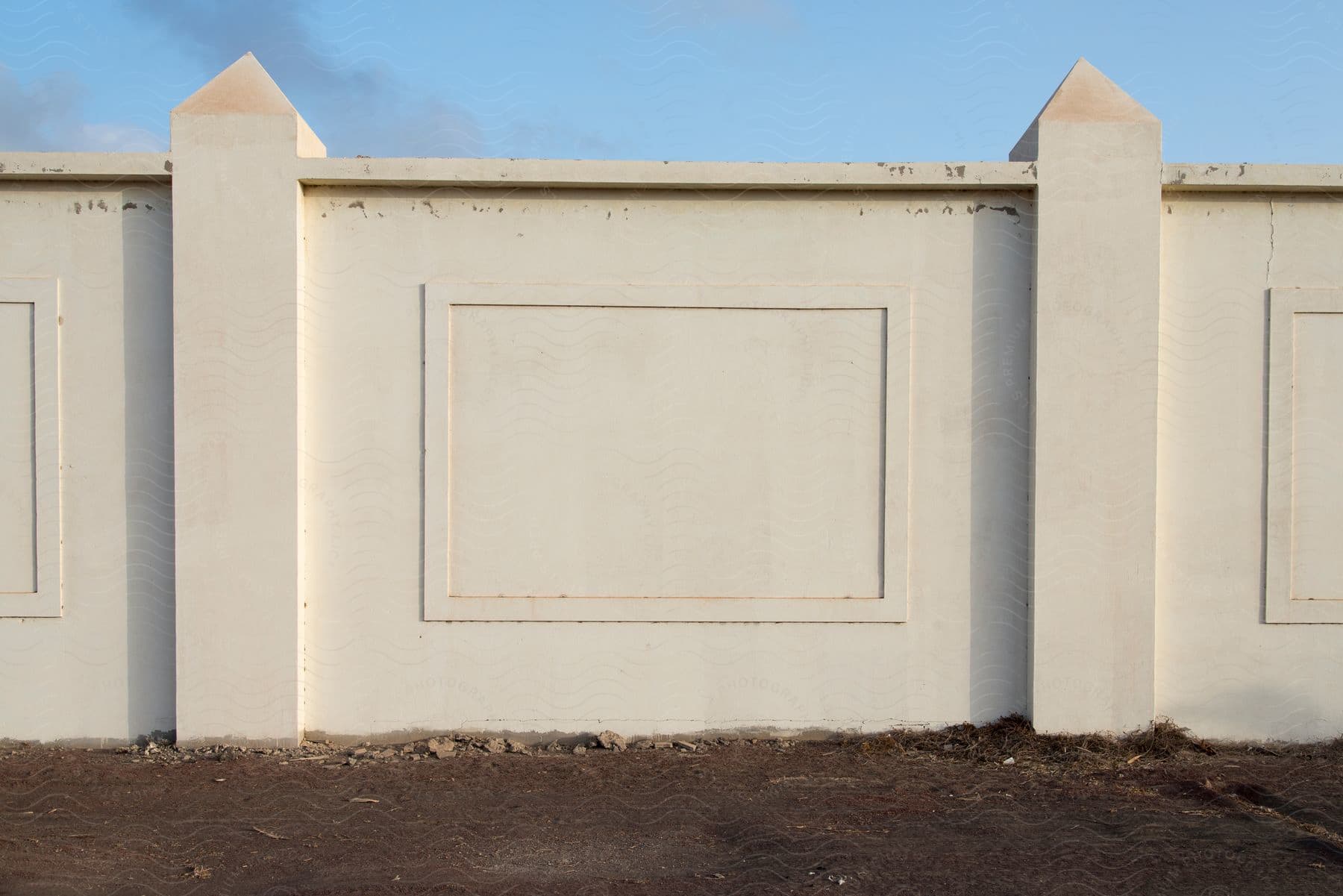 A white wall with a white rectangle carved in the center