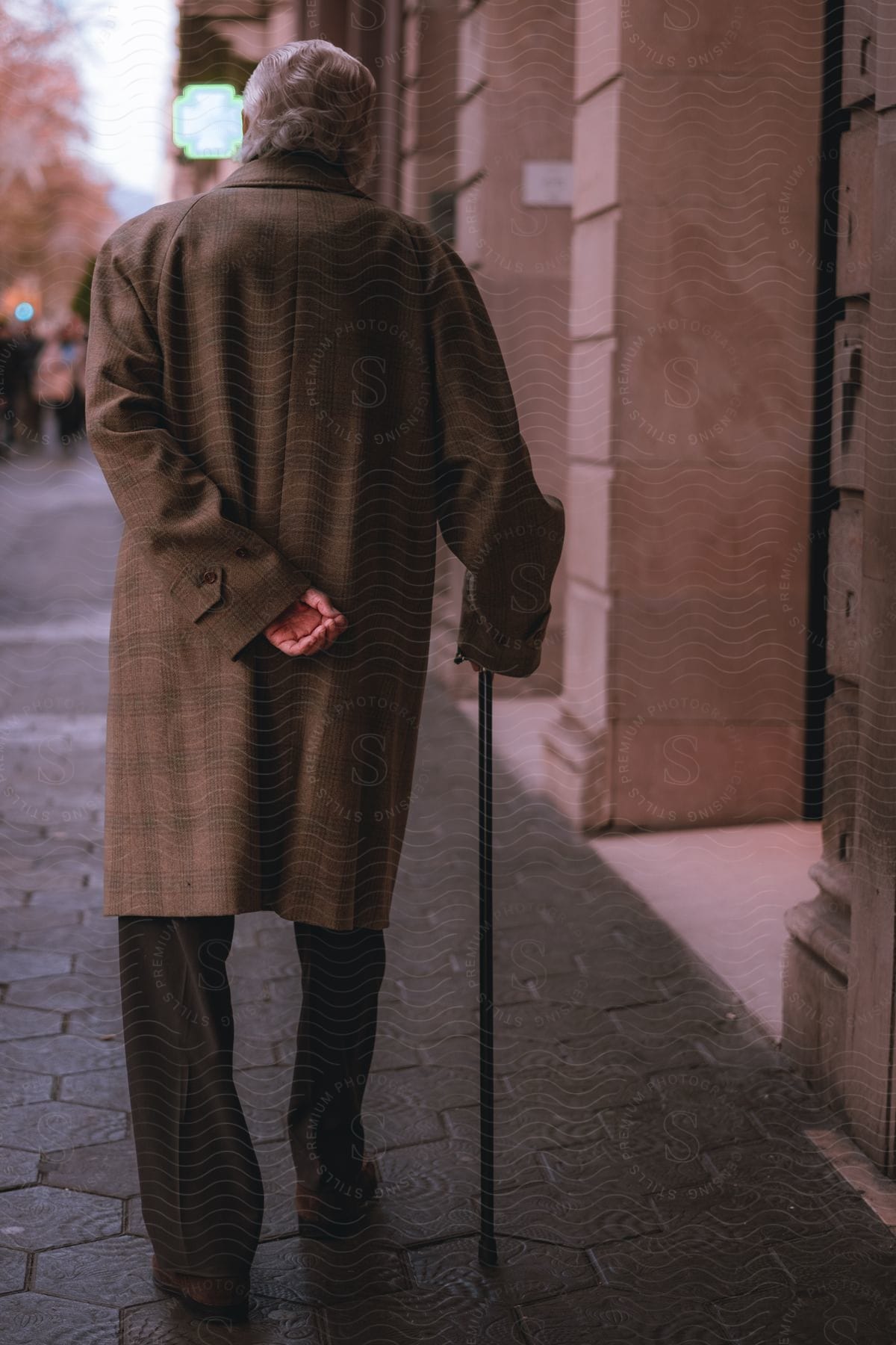 A man walking down a sidewalk in a city