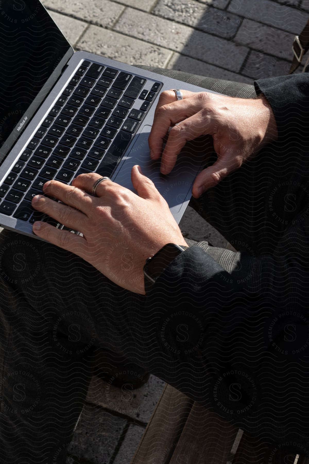 Stock photo of hands hover over laptop trackpad