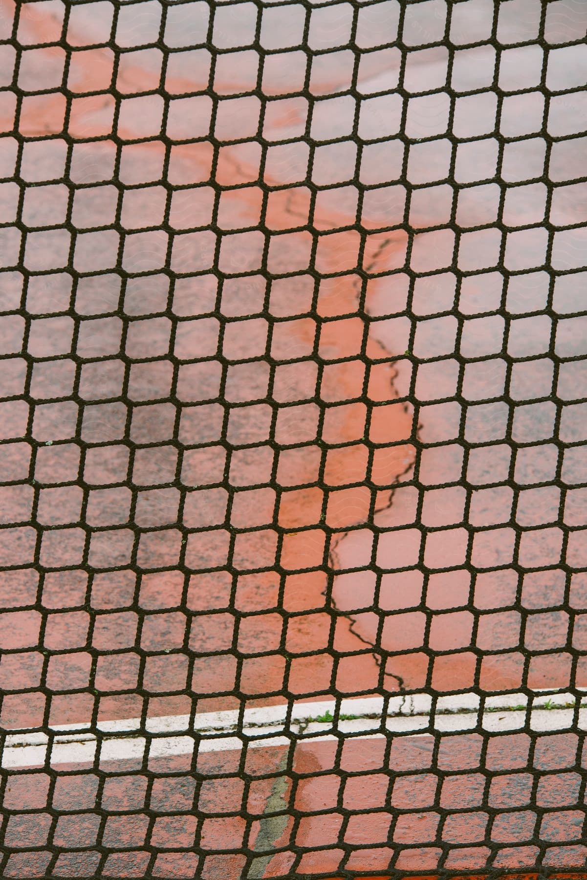 View of the side of a building though a chain link fence