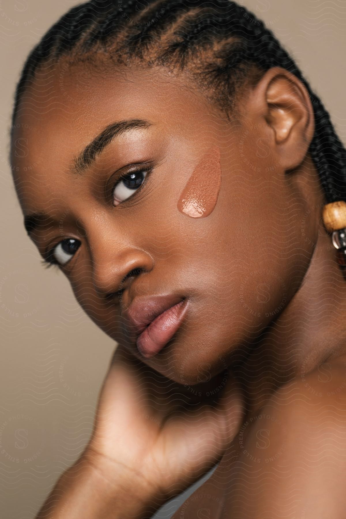 A person with liquid make-up on their clean face.