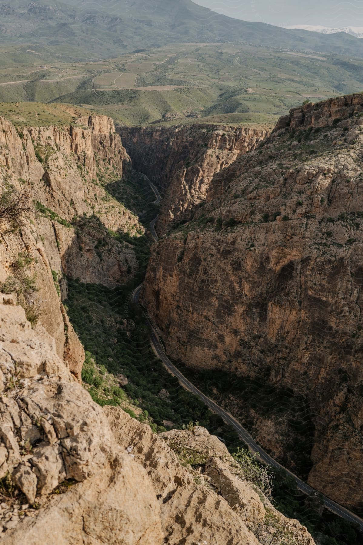 Aerial panorama of mountains with cliffs and ruins and a winding asphalt road