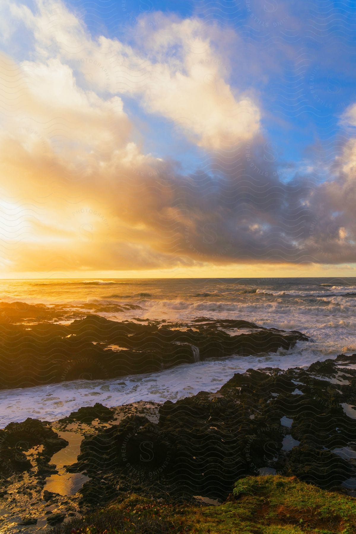 a fiery red sun dips below the horizon, casting a warm glow over the rippling waves of the ocean.