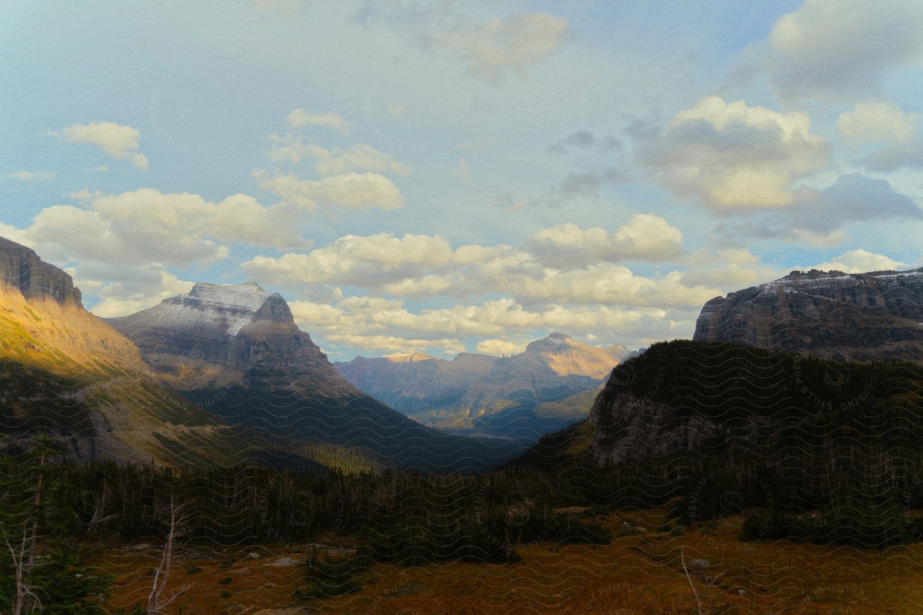 Sunset in a valley with hills and mountains.