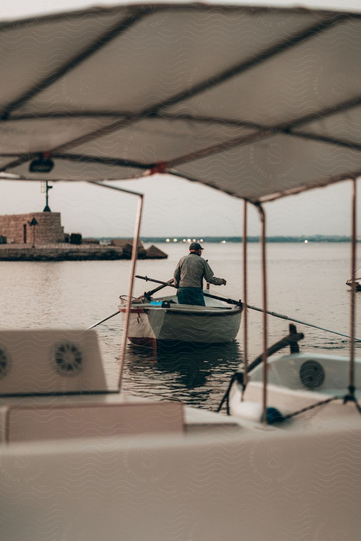 A man in a rowboat out on the water