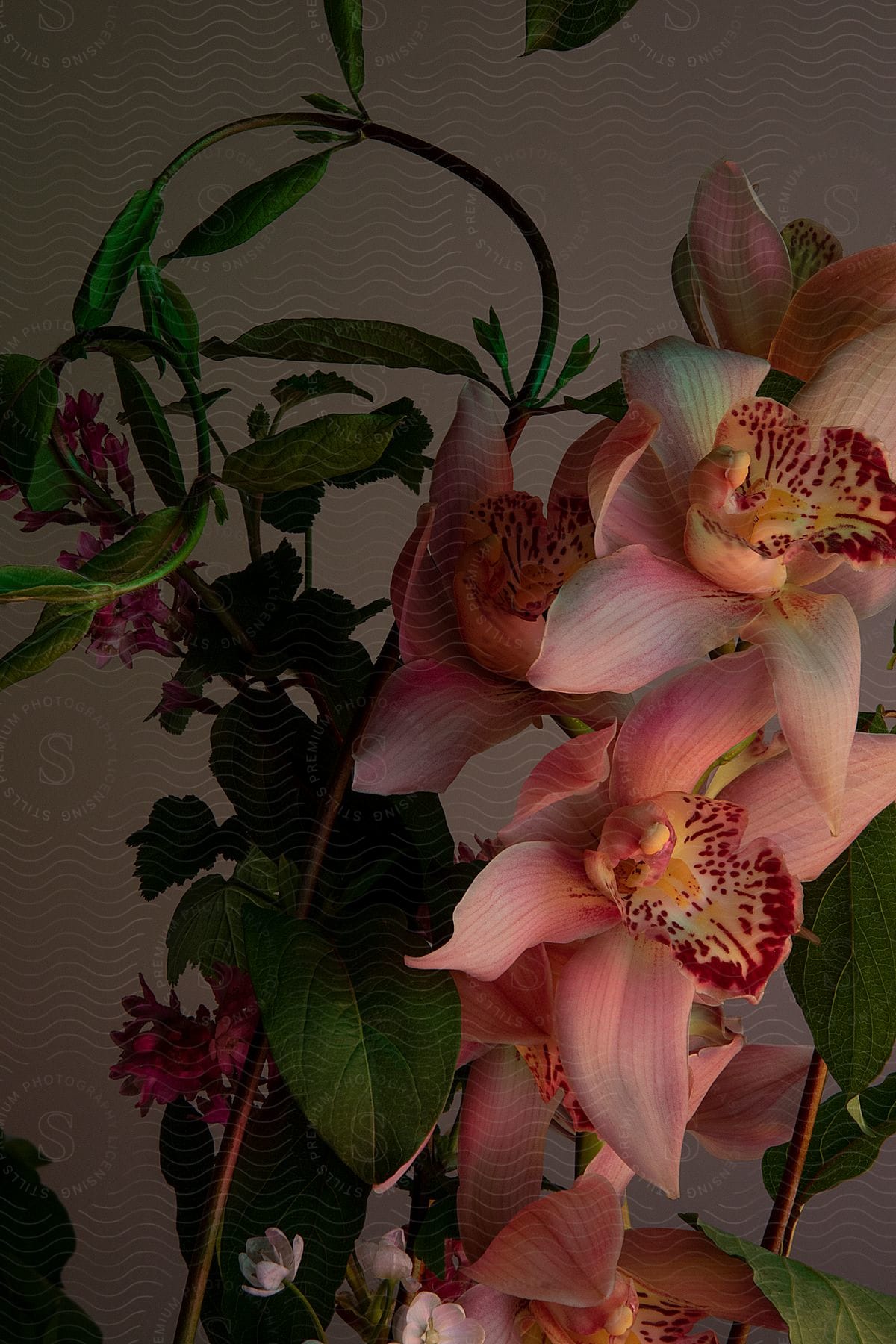 a bunch of pink flowers in a glass vase on a table