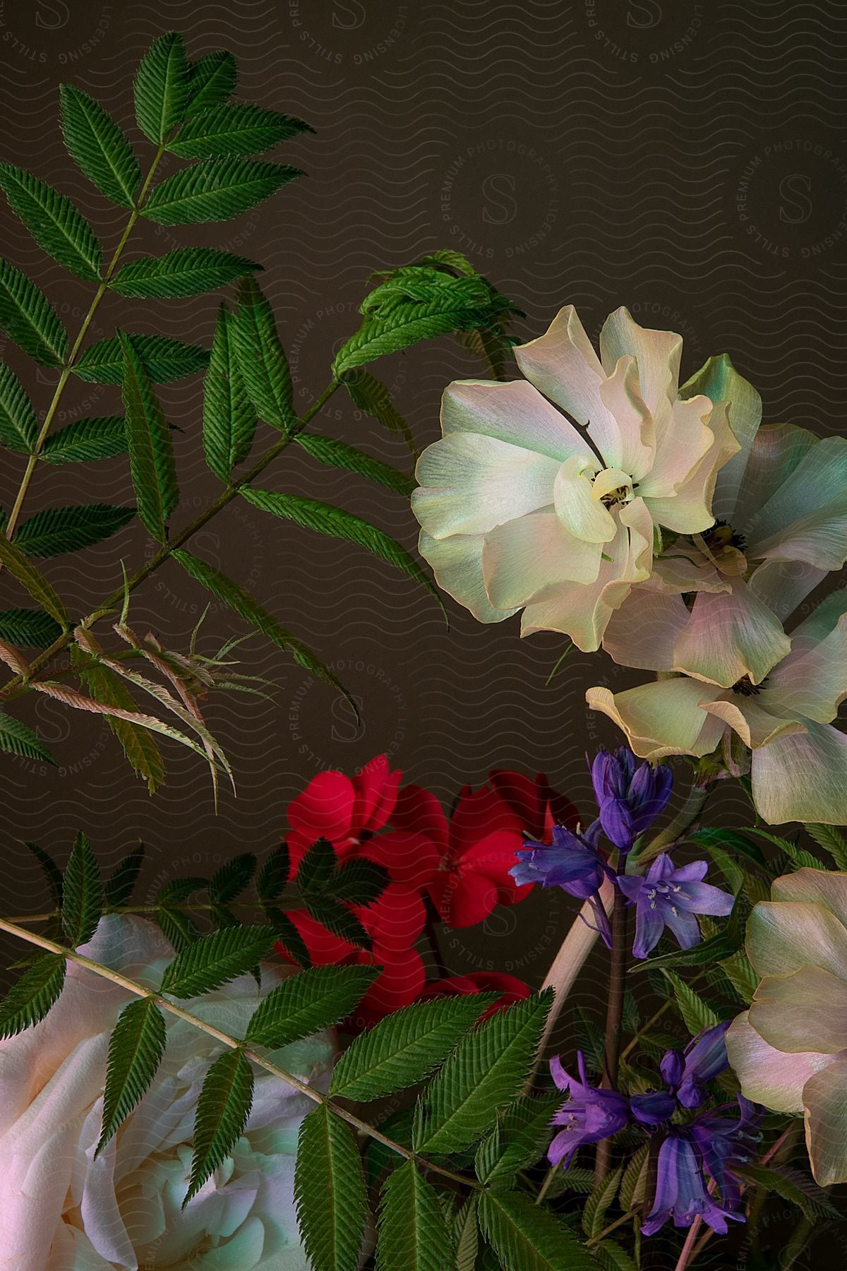 Green leaves on stems accent flower arrangement