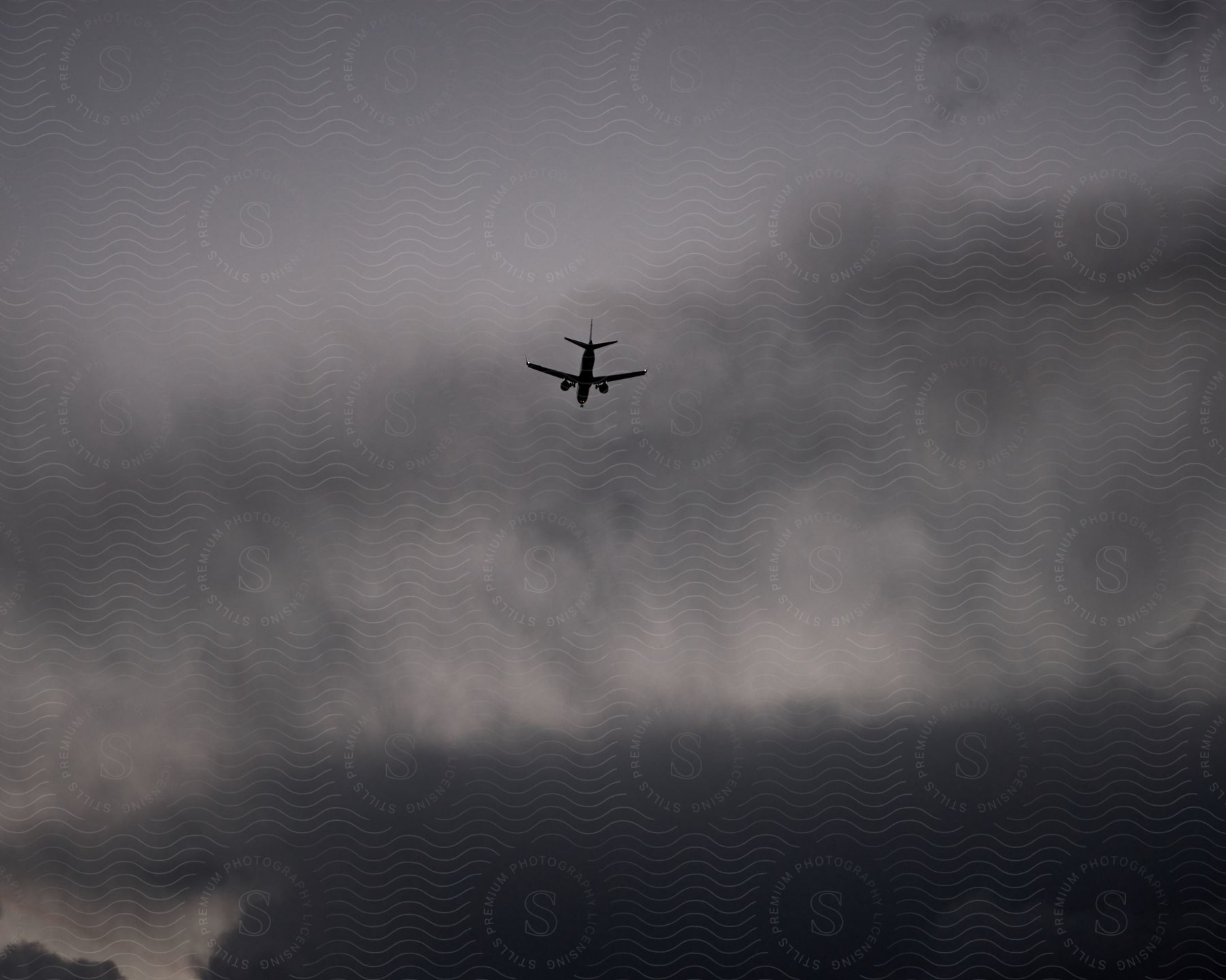 A plane flying into some clouds in the sky