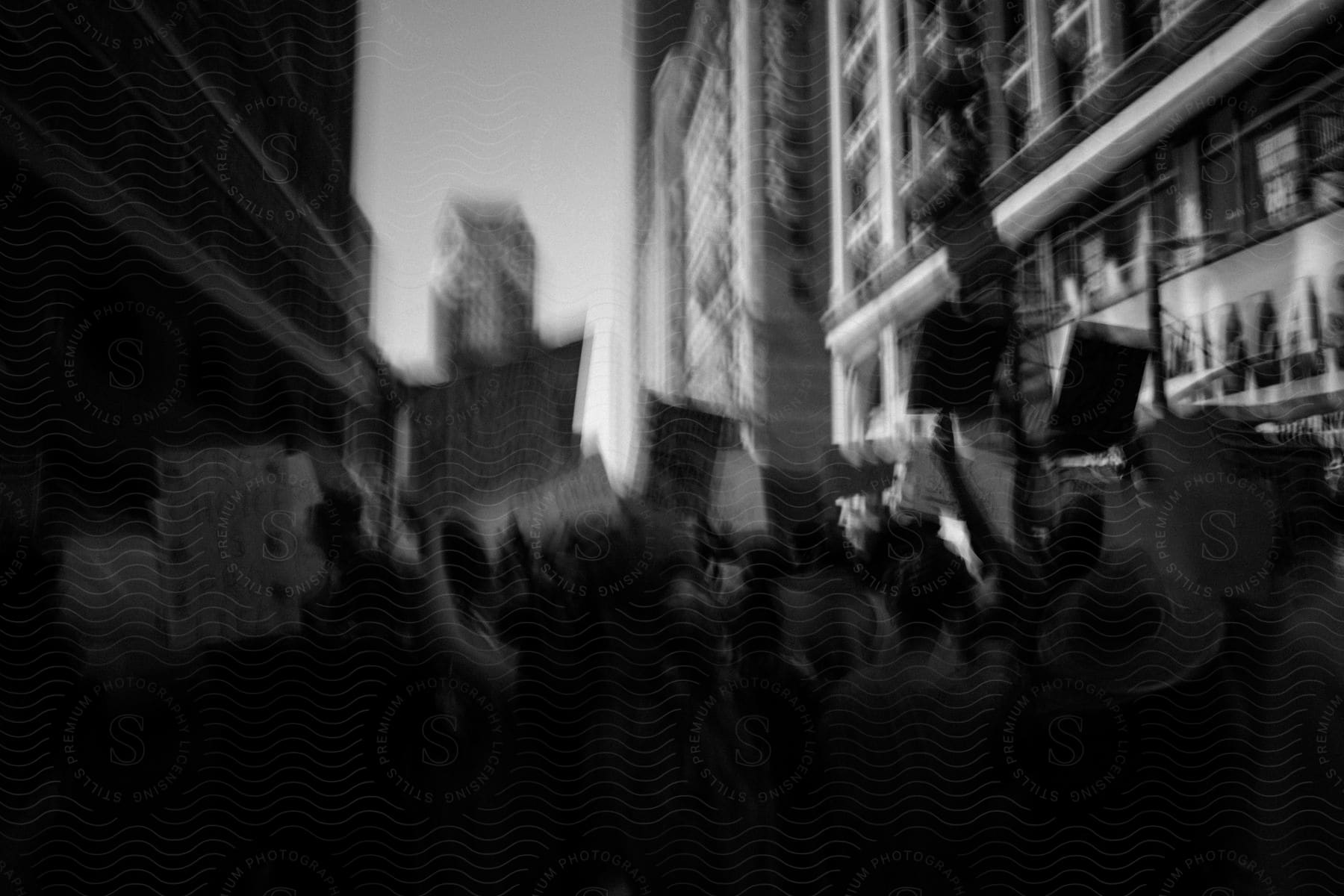 A small group of people in a city celebrating with flash photography in front of a building