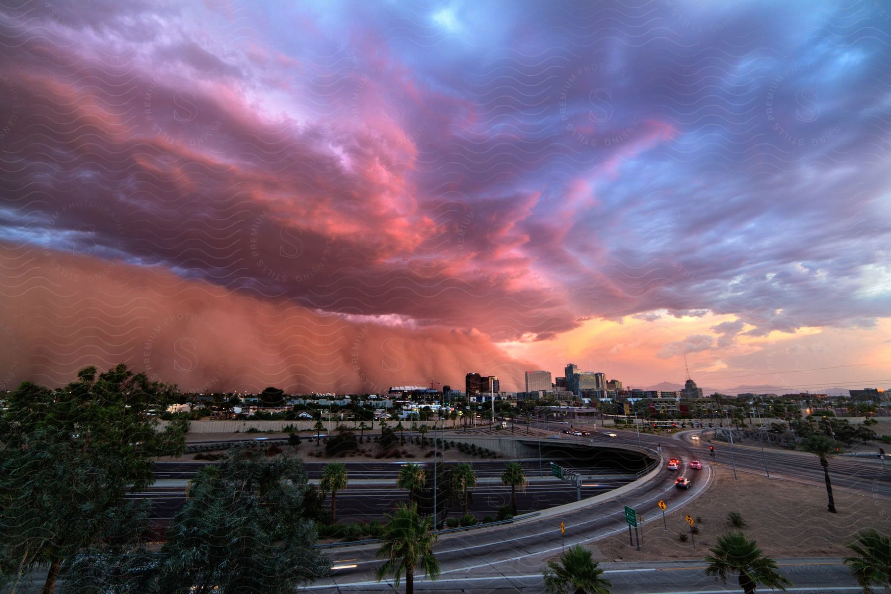 A dust storm and lowlevel clouds roll into downtown phoenix at sunset