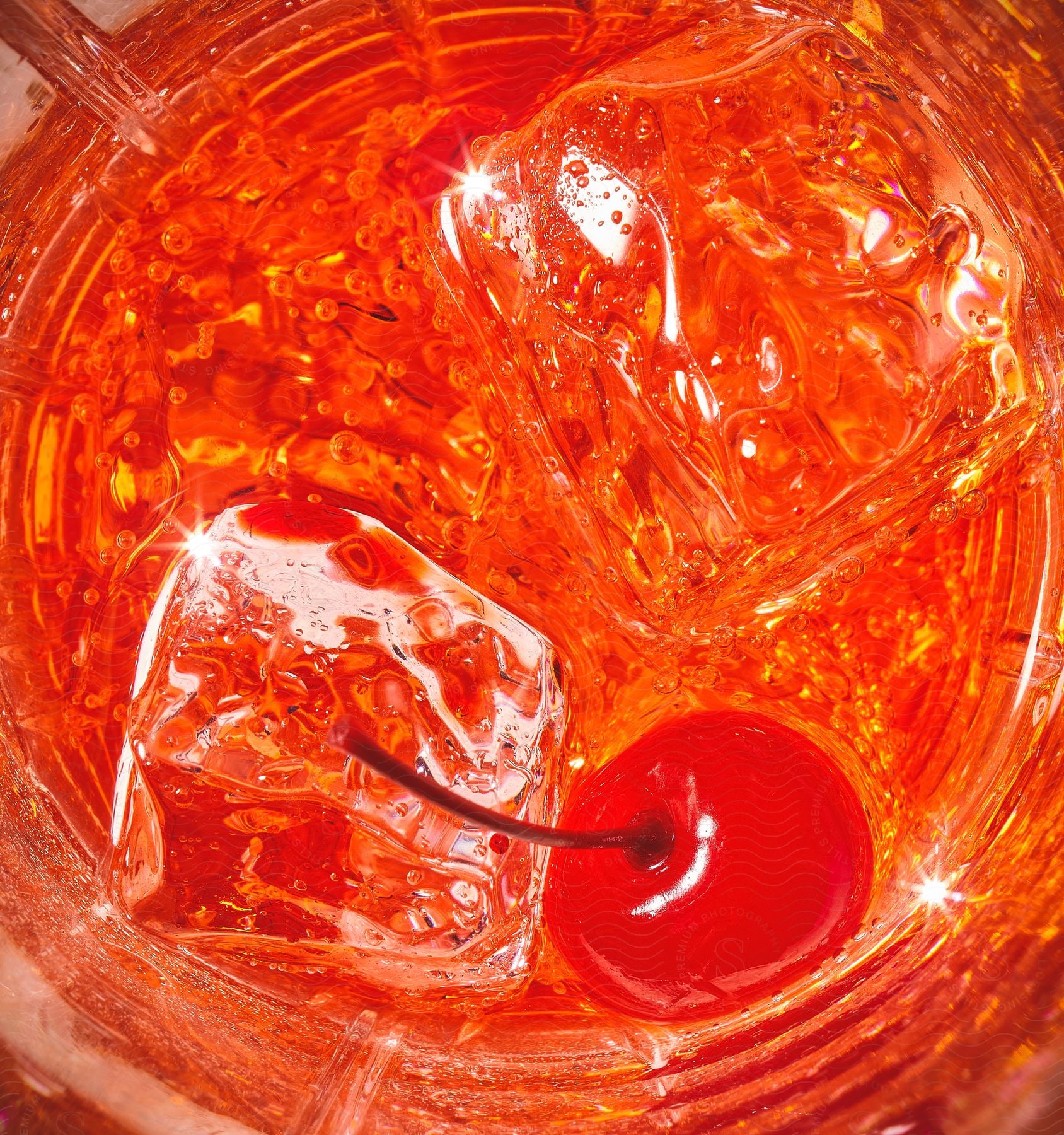 Close up of red liquid beverage with ice cubes