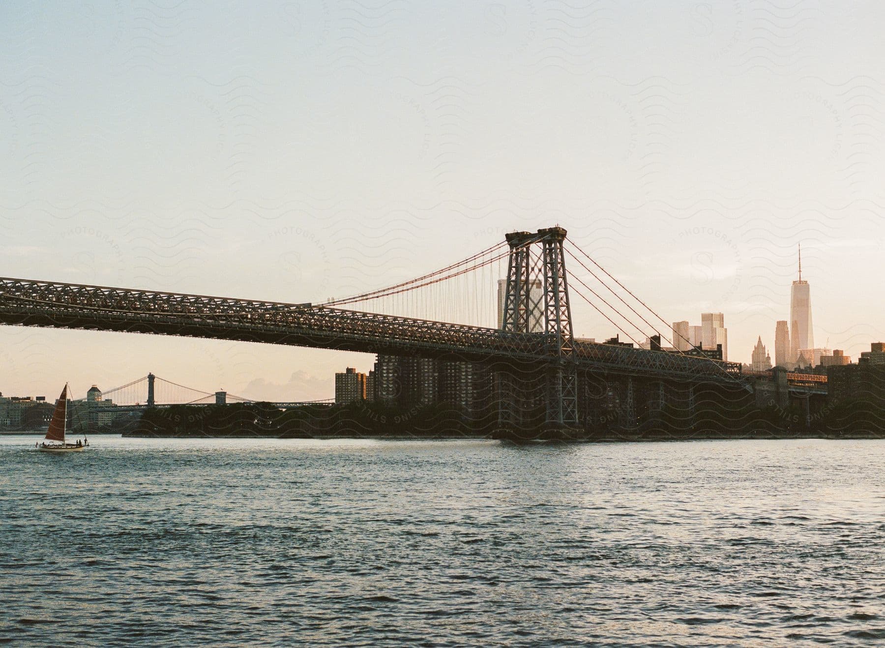 A boat on a lake with a cityscape in the background at dusk