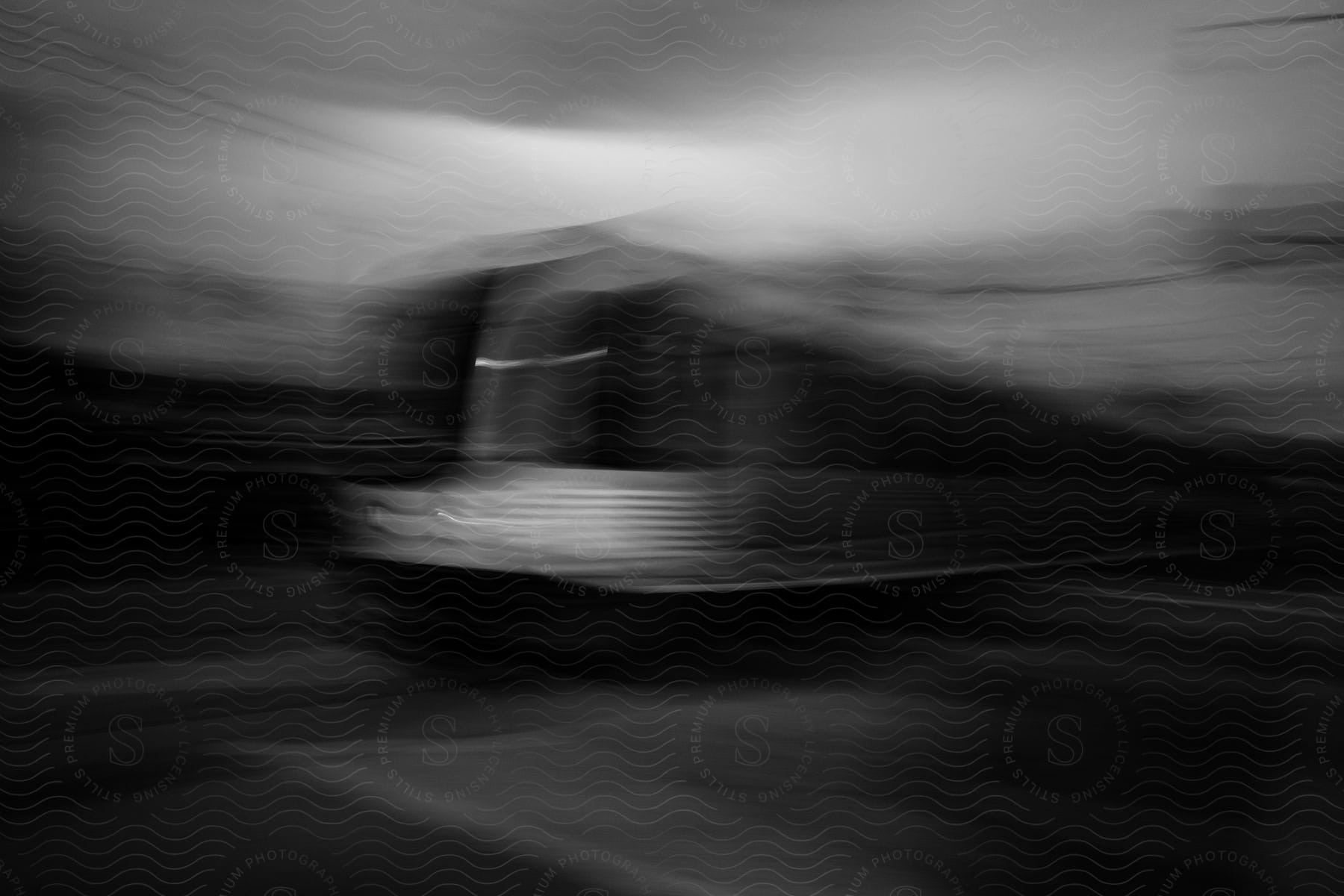 A bus travels down the street in black and white