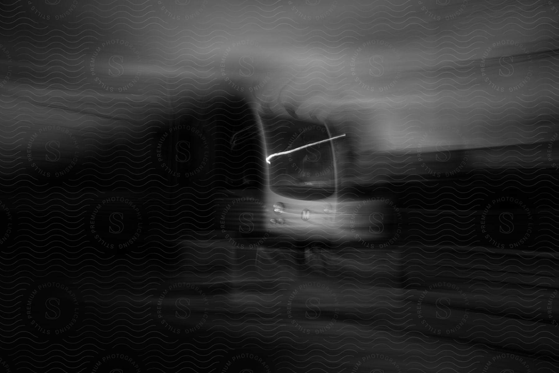 A speeding subway train captured in black and white