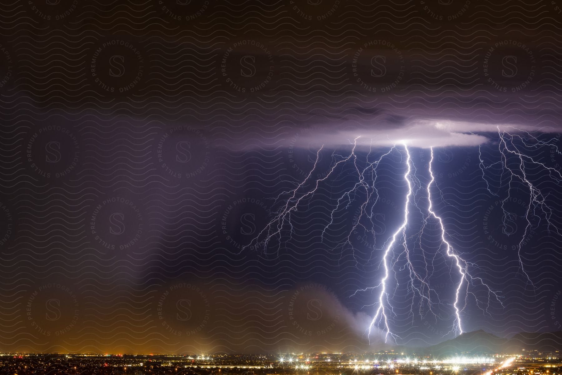 A lightning illuminates a fast moving haboob across the southeast valley with the san tan mountains on the right