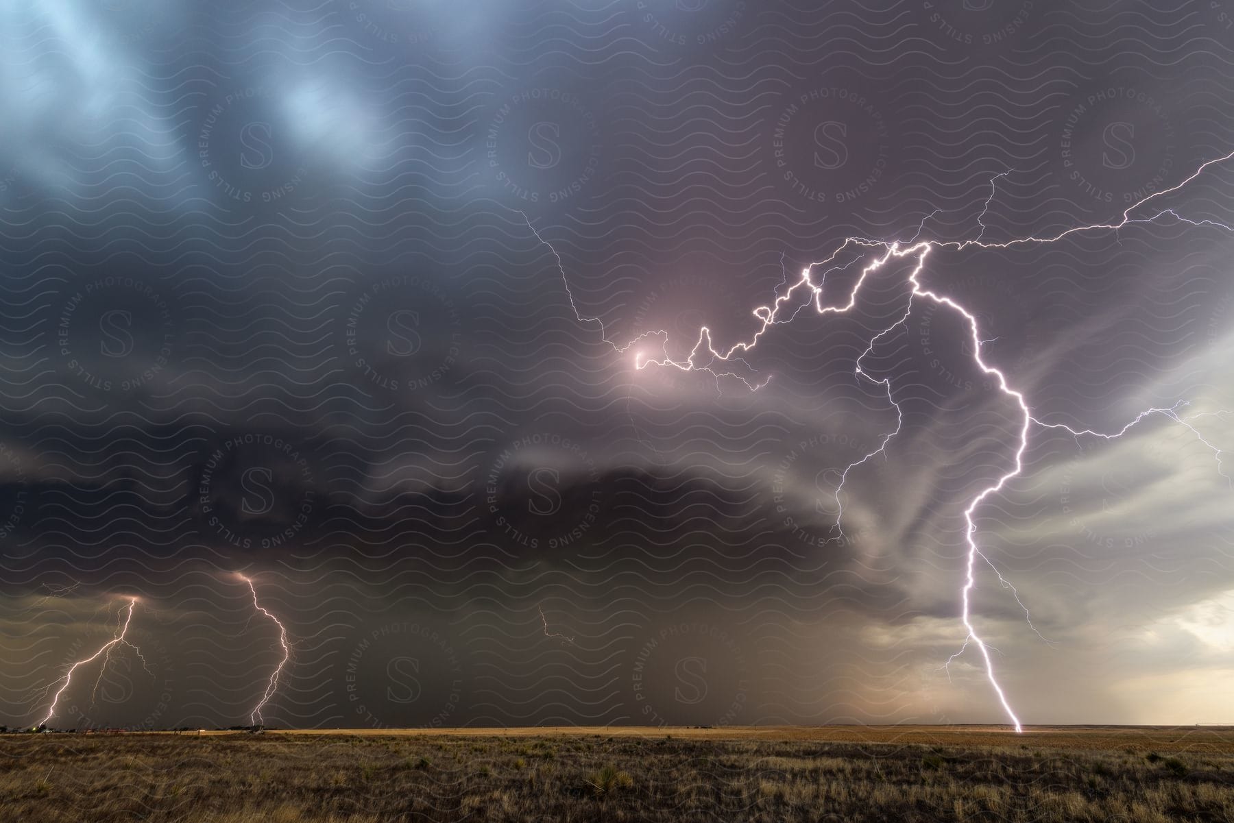 A lightning storm and clouds forming in a flat landscape