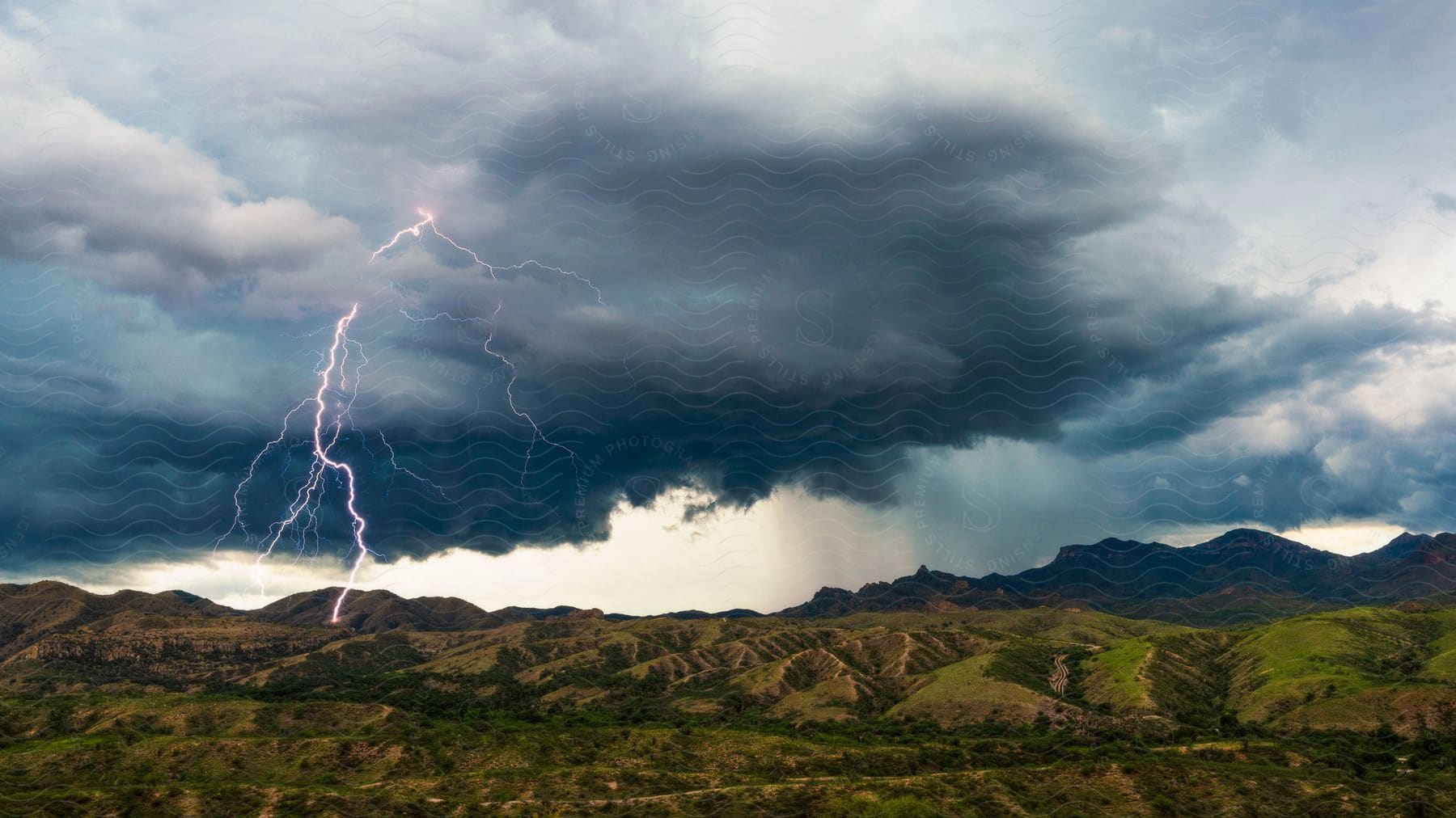 A lightning bolt strikes near castle rock in the mountains of the coronado national forest highlighting the power of nature