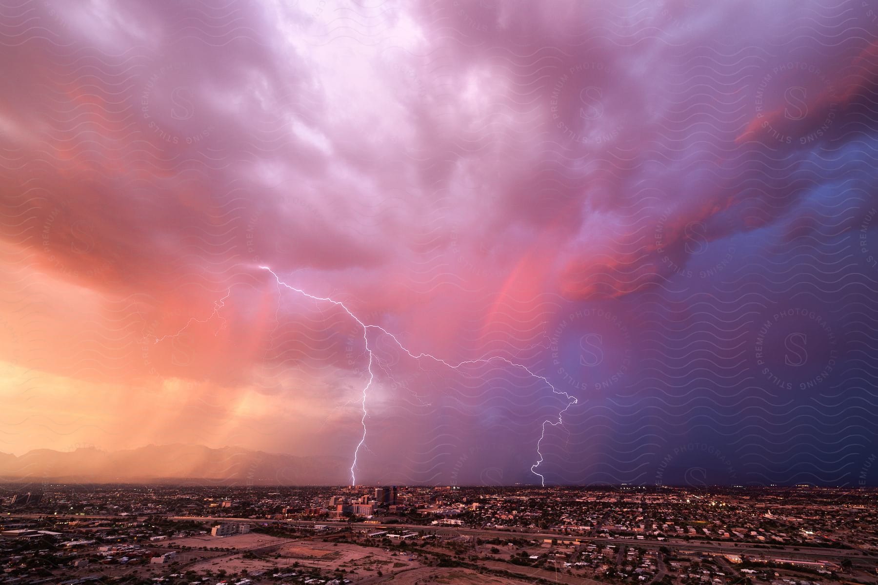 A huge lightning storm over a suburban town at night