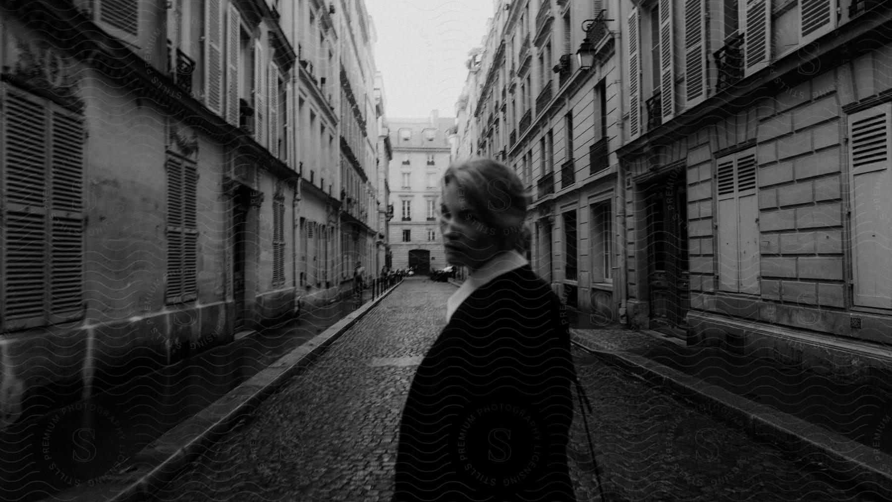 A woman walking on the street looking back over her shoulder