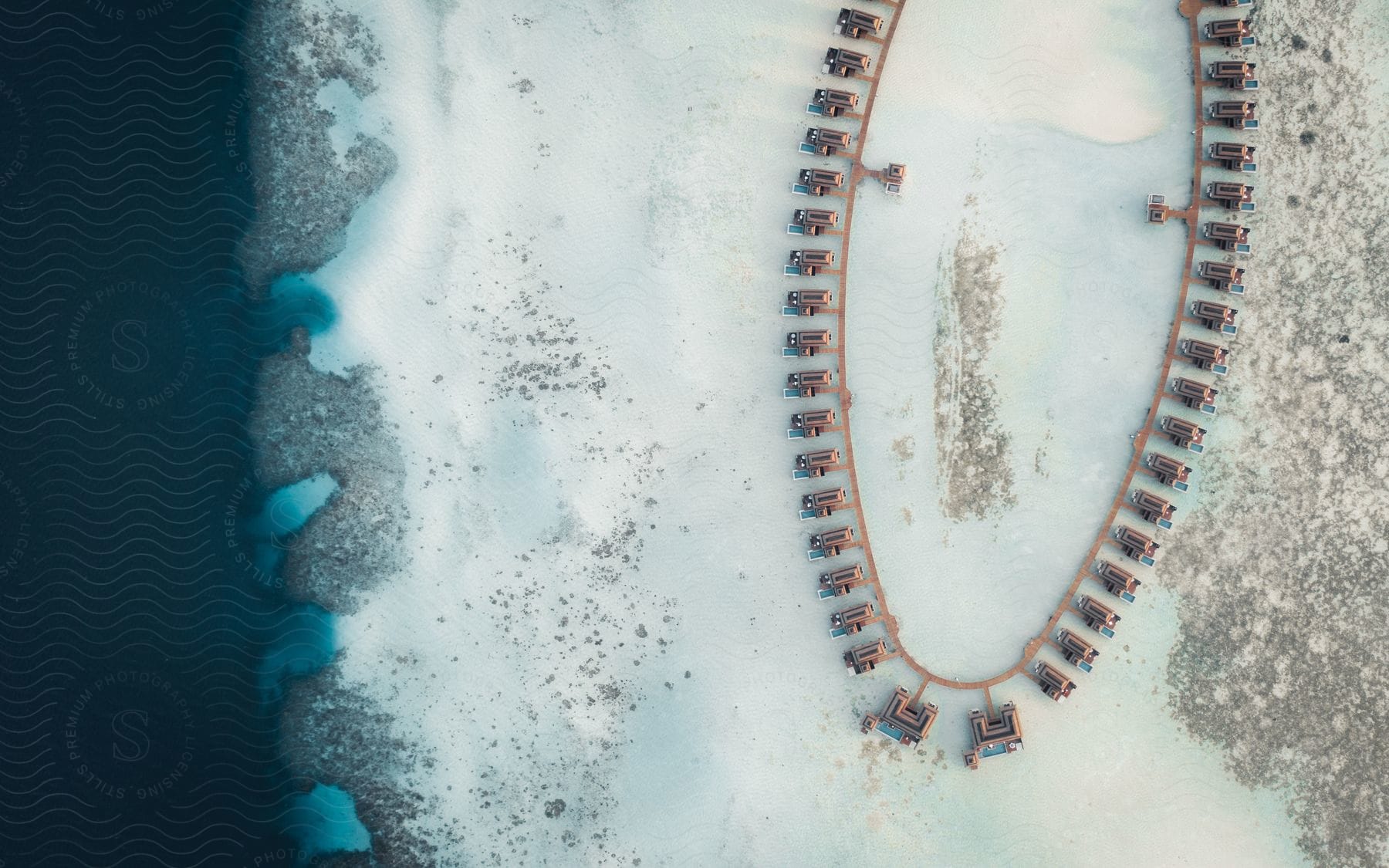 Aerial view of a whitish body of water with a round design in the middle