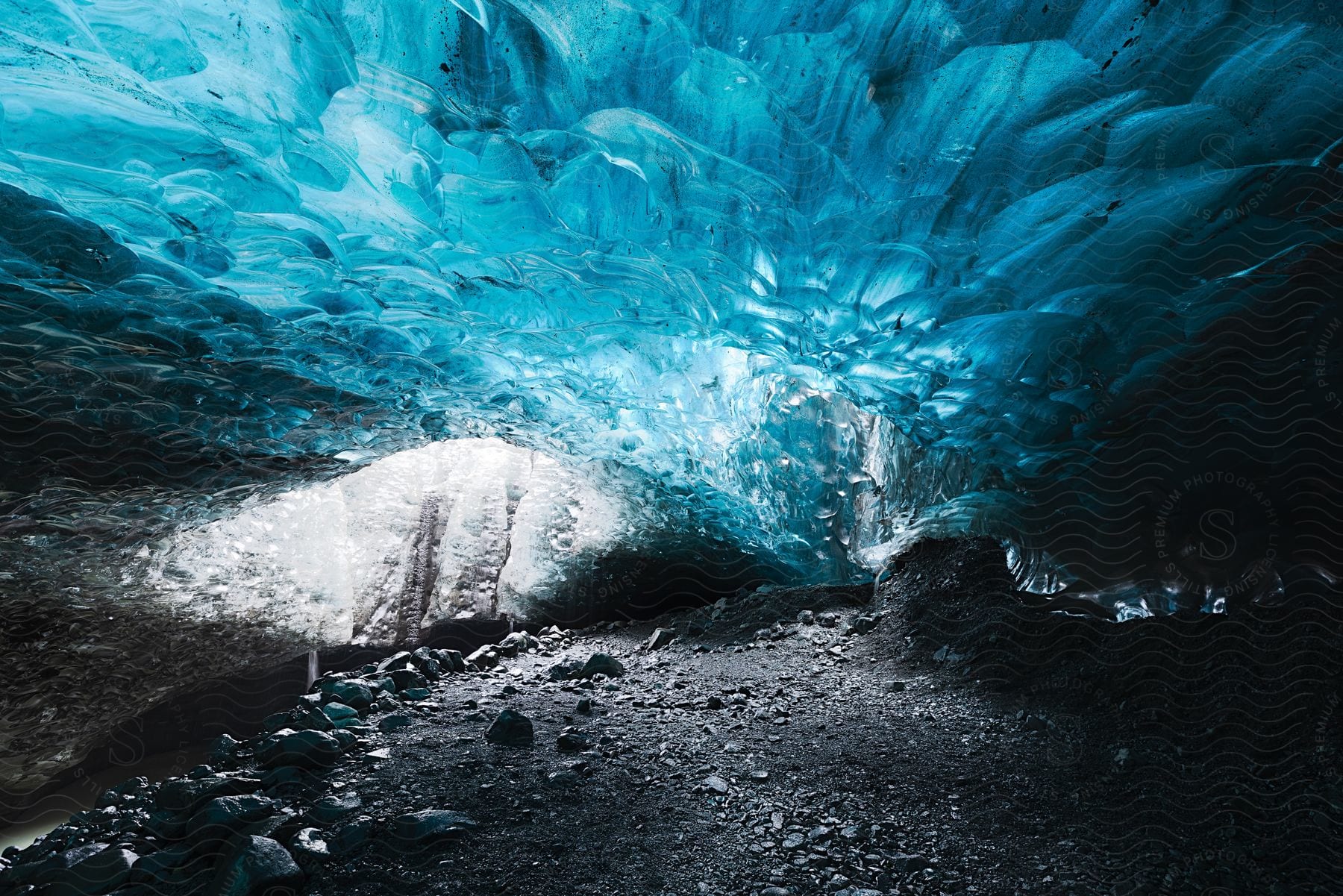 A serene ice cave nestled within a mountain in iceland