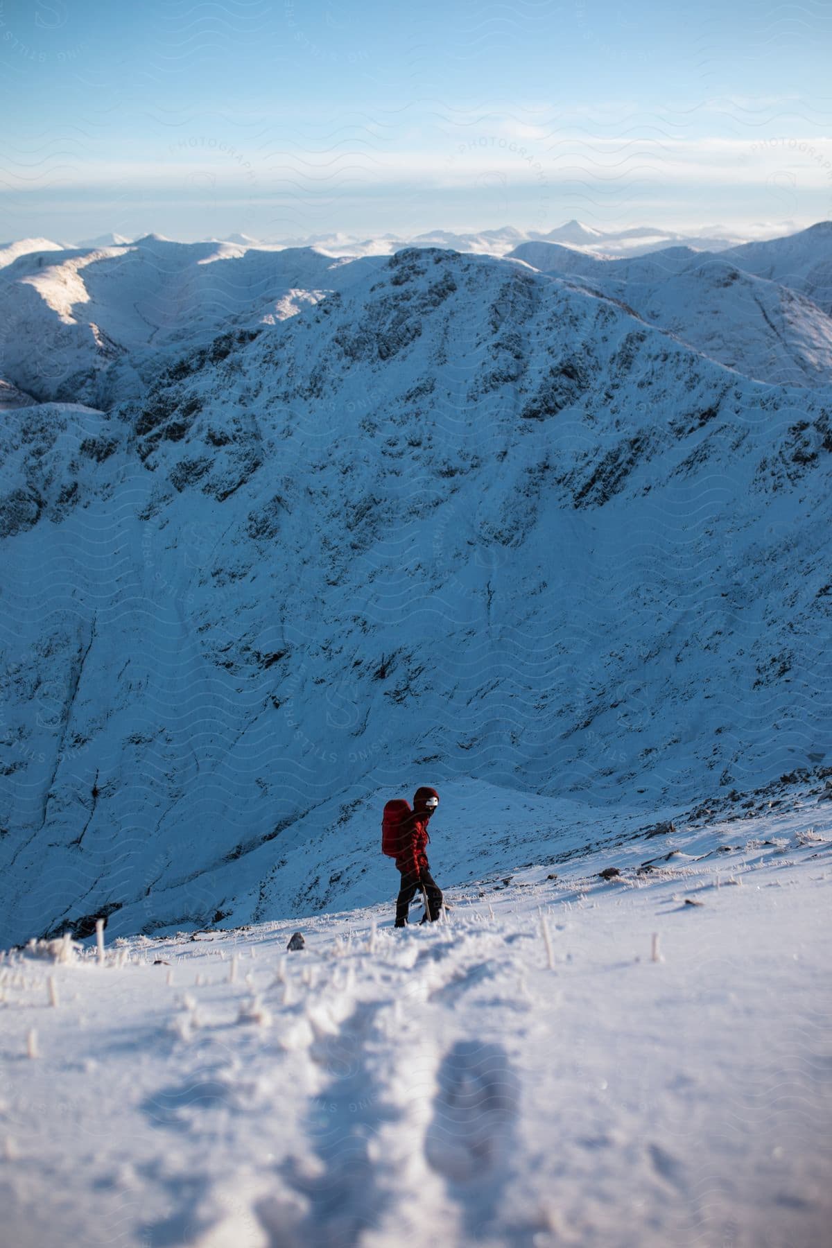 A person hiking through snowy mountains during winter