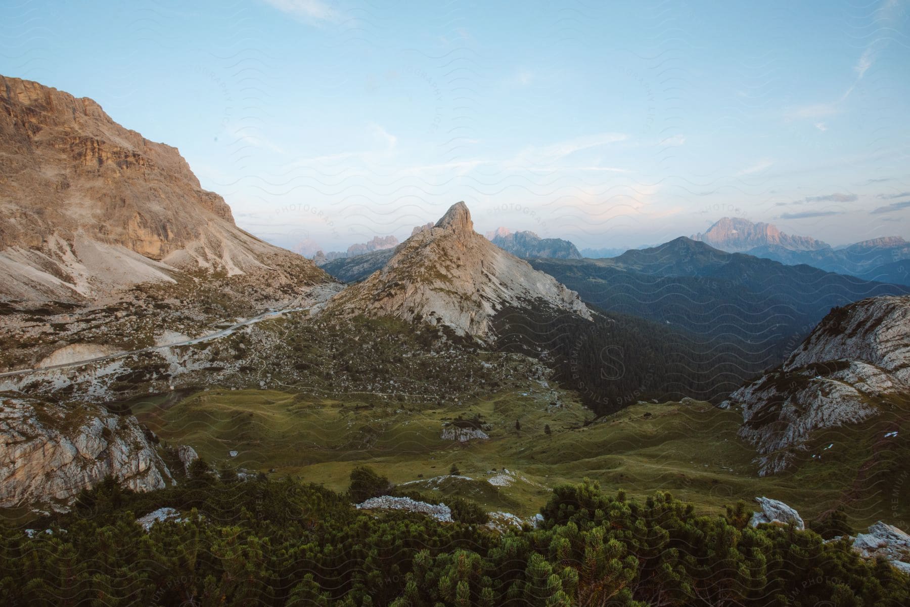 A wide landscape of valleys and mountains with trees