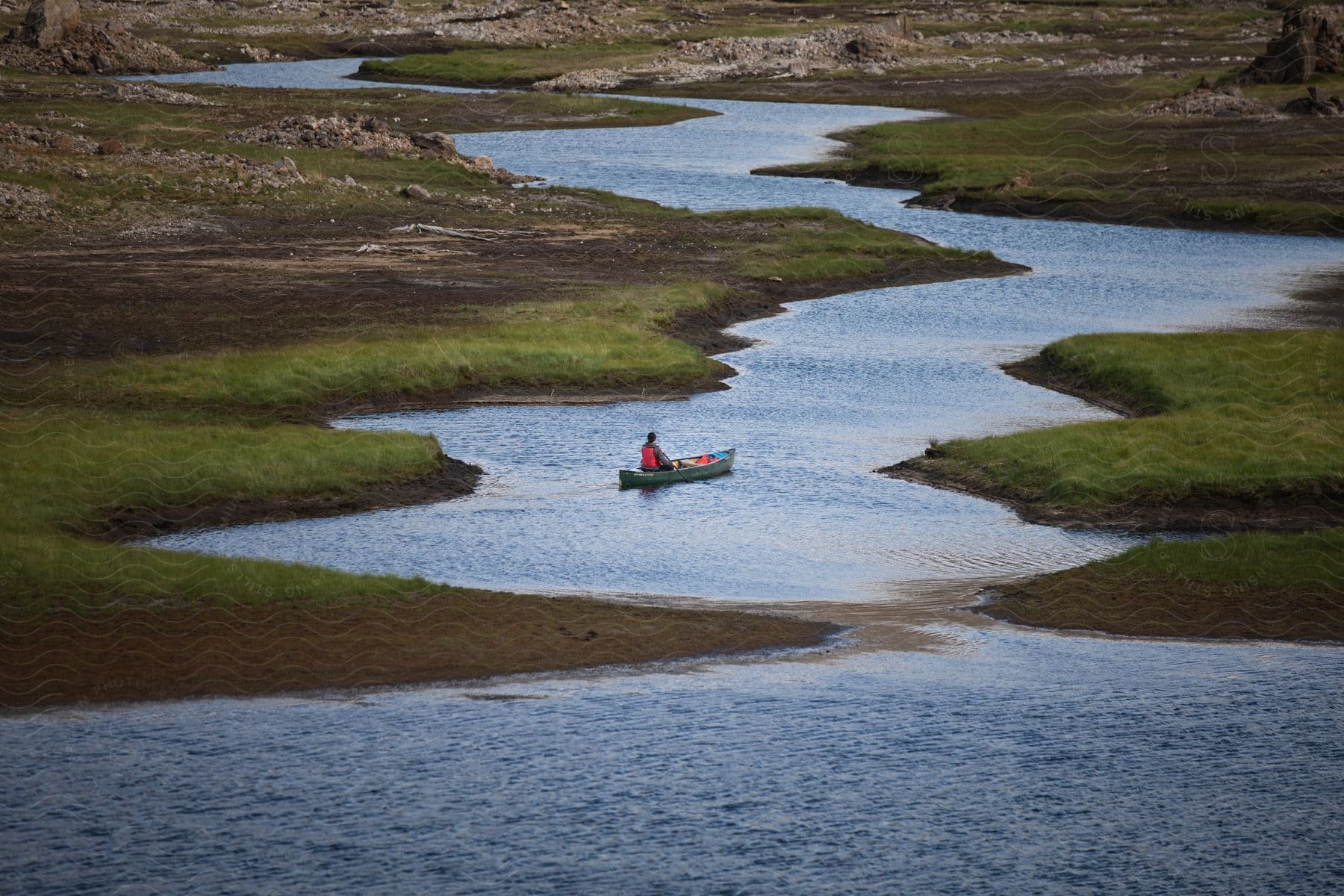 A person on a small boat on a river during the day in scotland