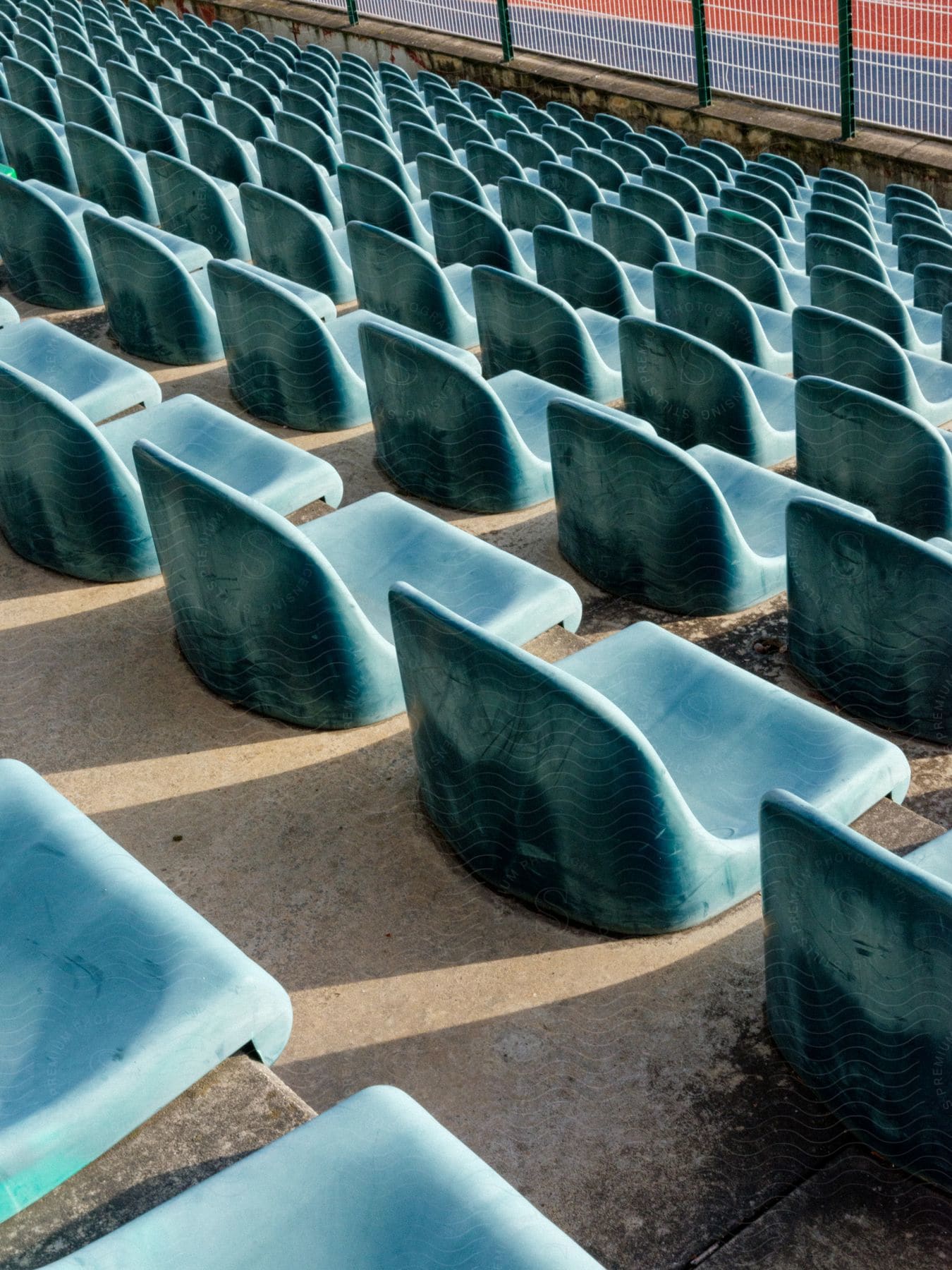 Worn plastic chairs lined up in an outdoor setting