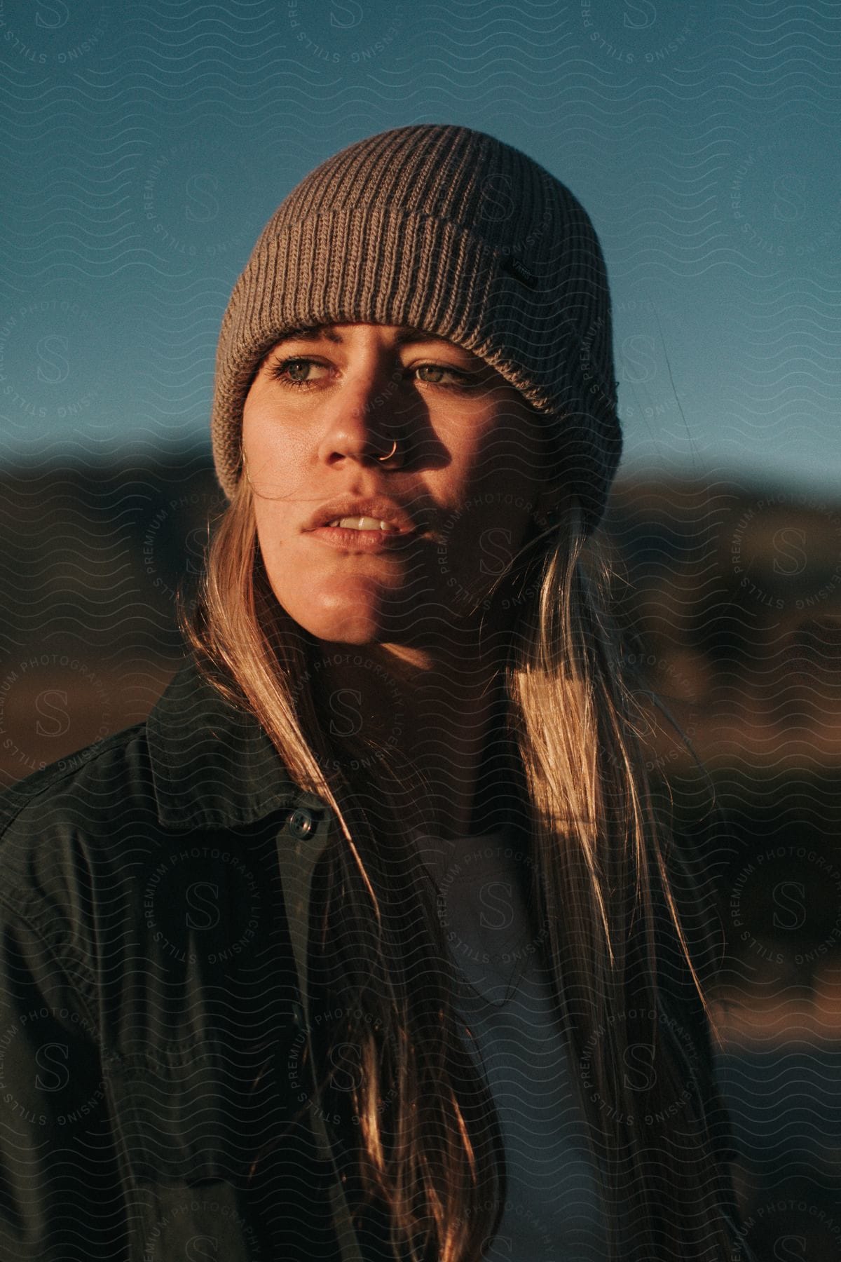 A caucasian lady wearing a head warmer and a black jacket