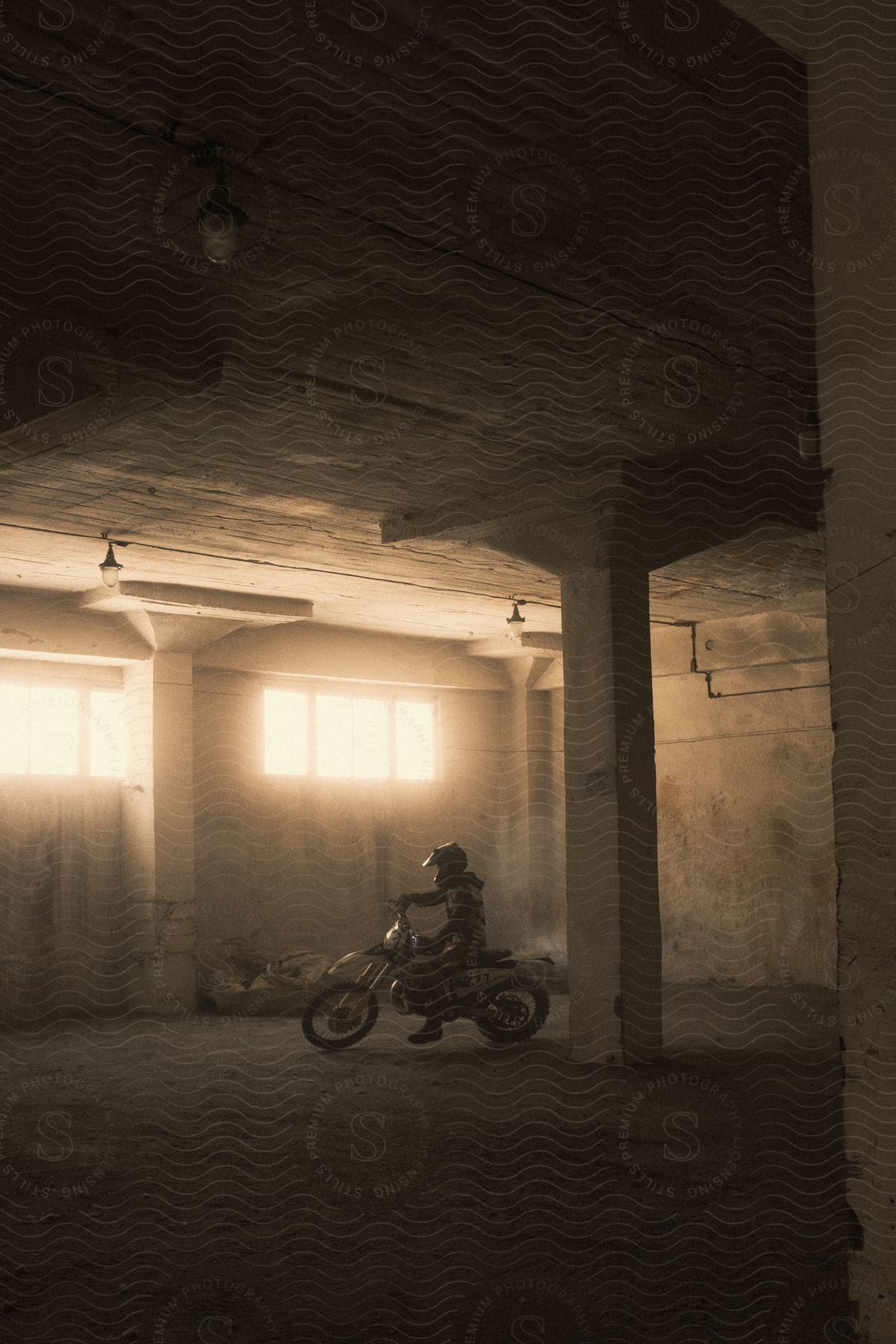 A man performing motorcycle tricks indoors