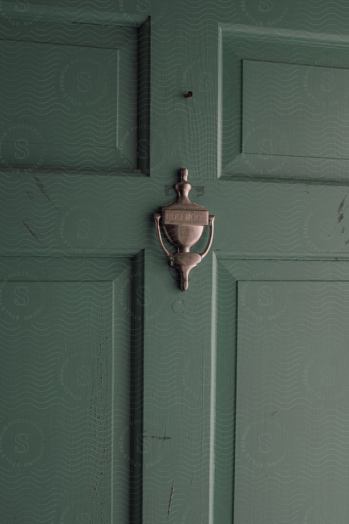 A wooden door with a handle and dead bolt