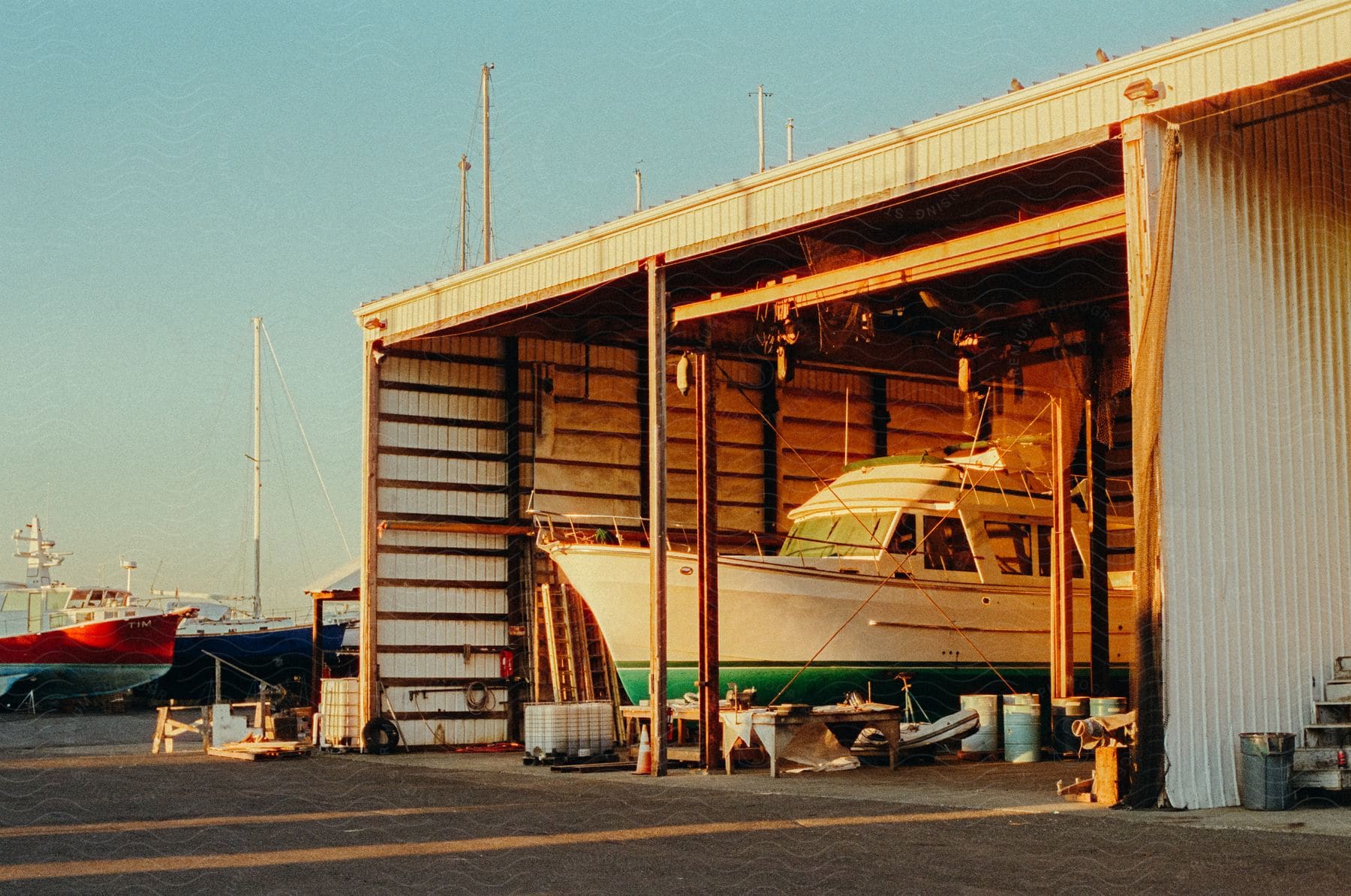 A boat being refitted on a warehouse in a pier at evening