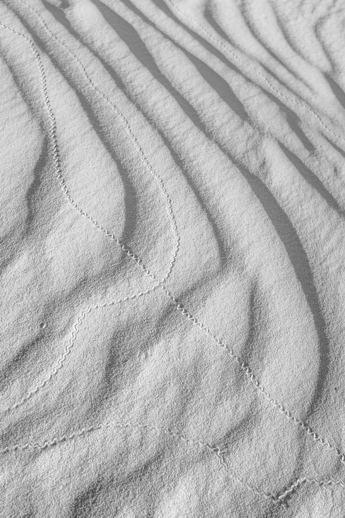 A photograph of totally white fabric with white sewing lines captured in a still life composition