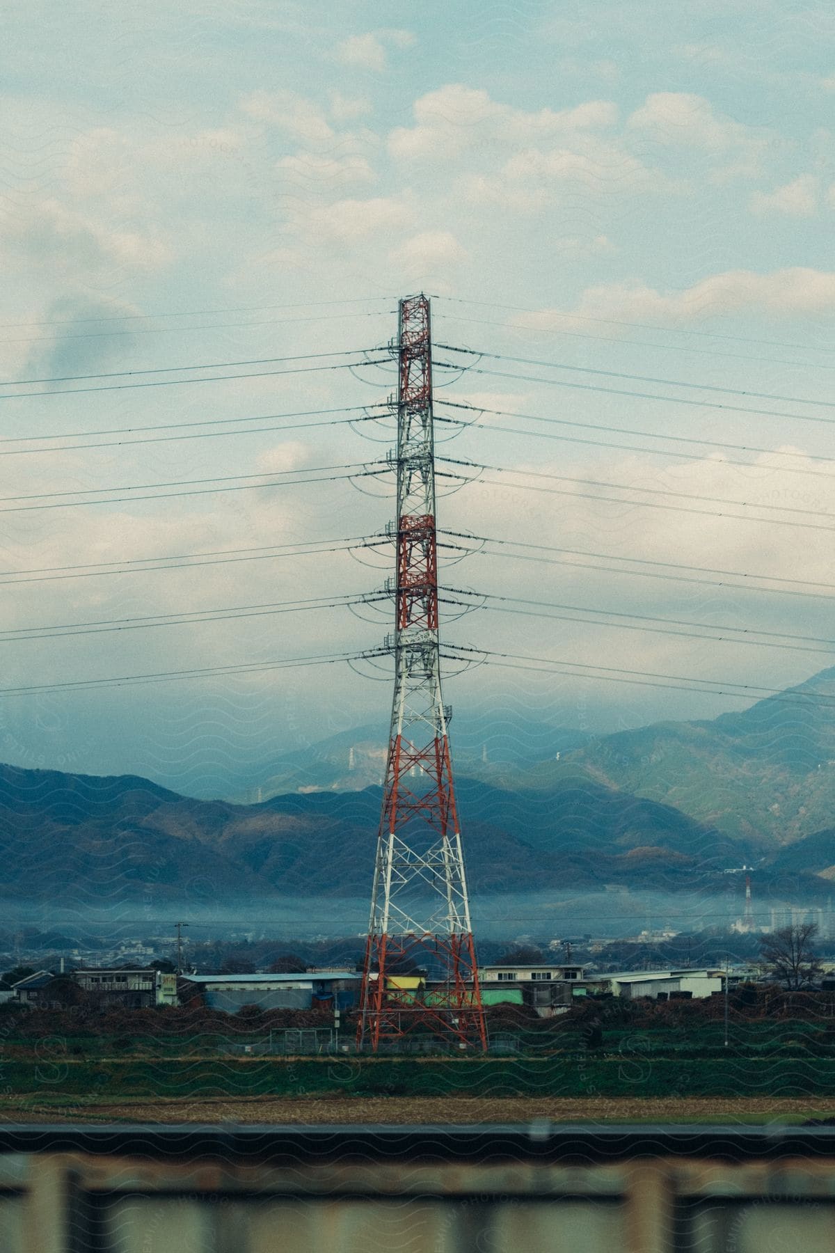 An electrical tower in front of a mountain range