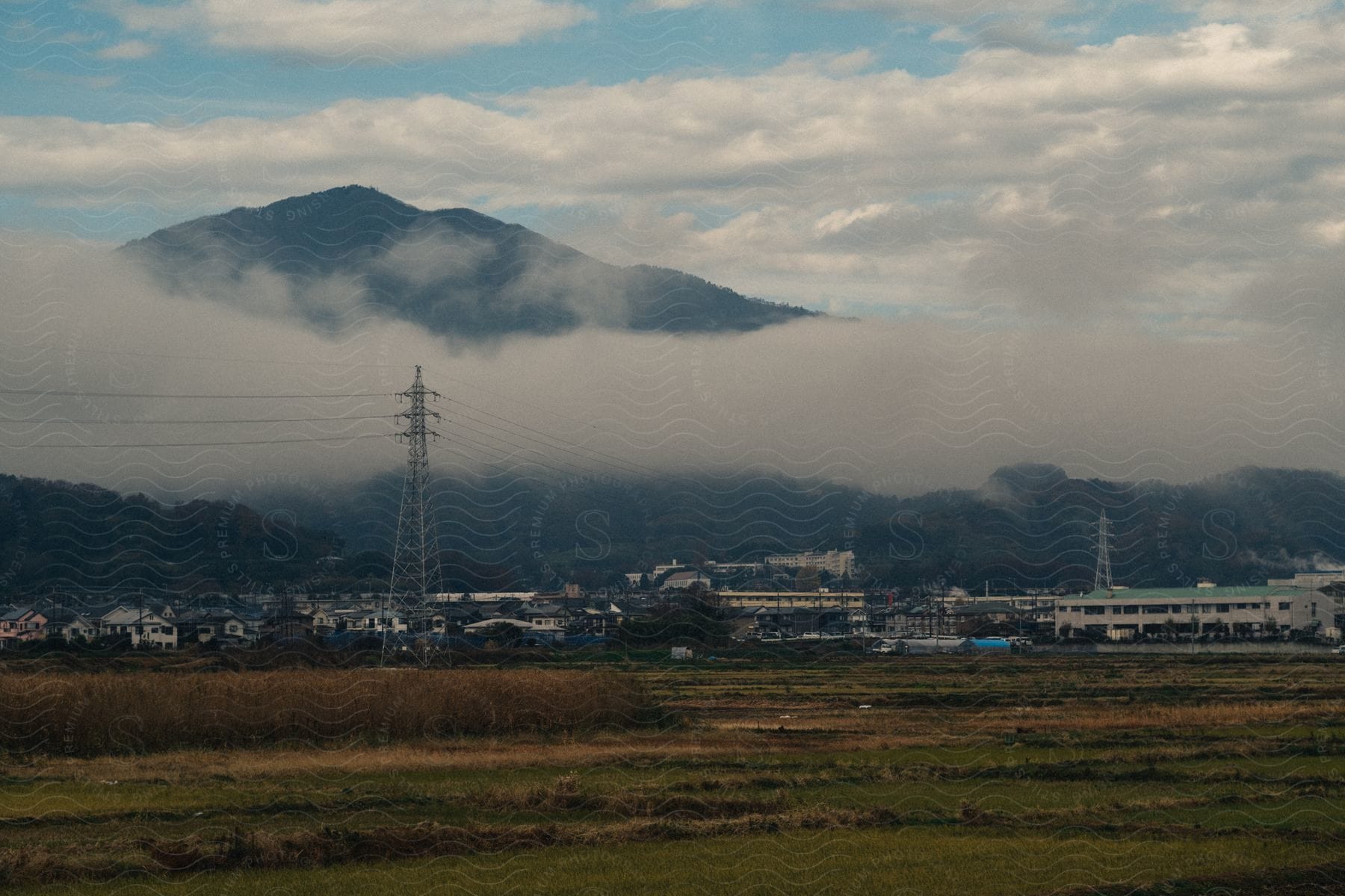 A mountain landscape with fog and power lines