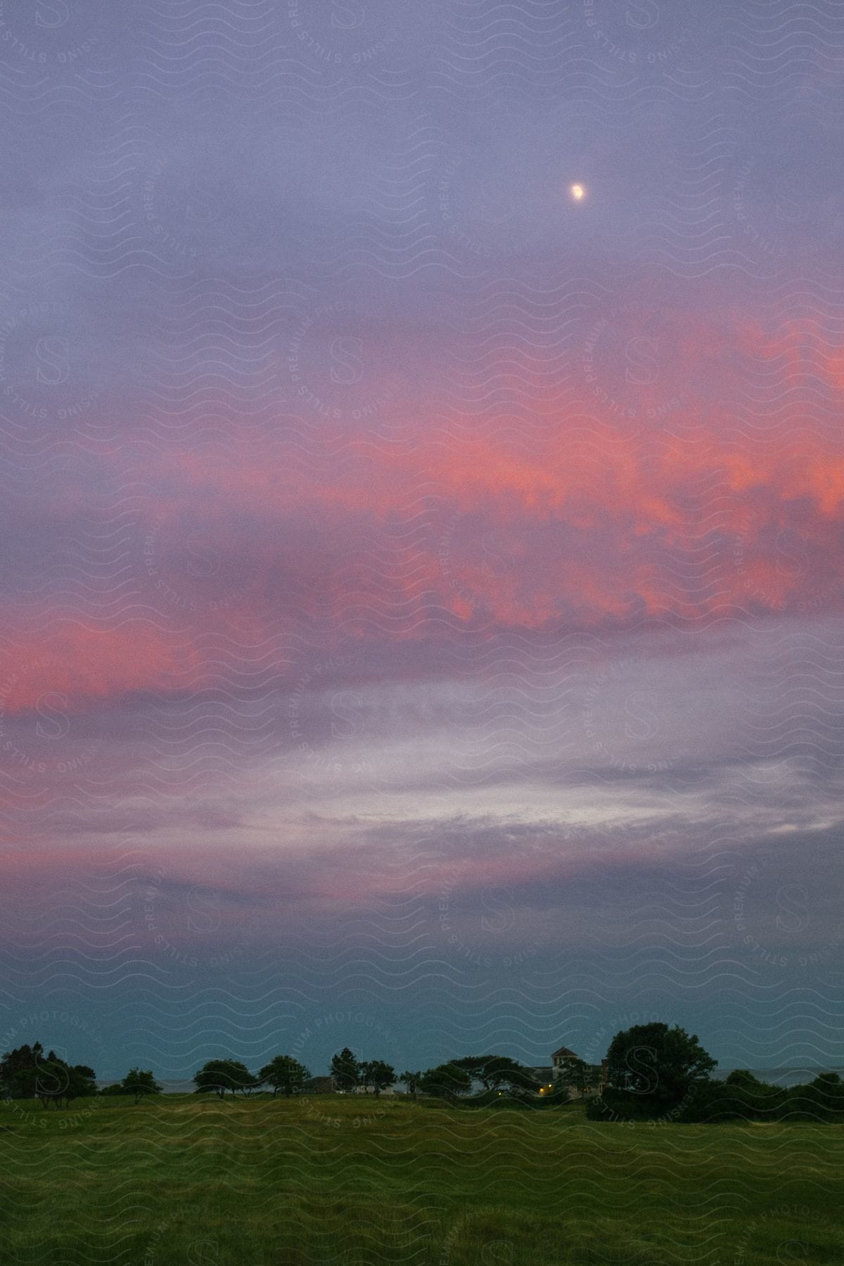 Sun setting in horizon over a field