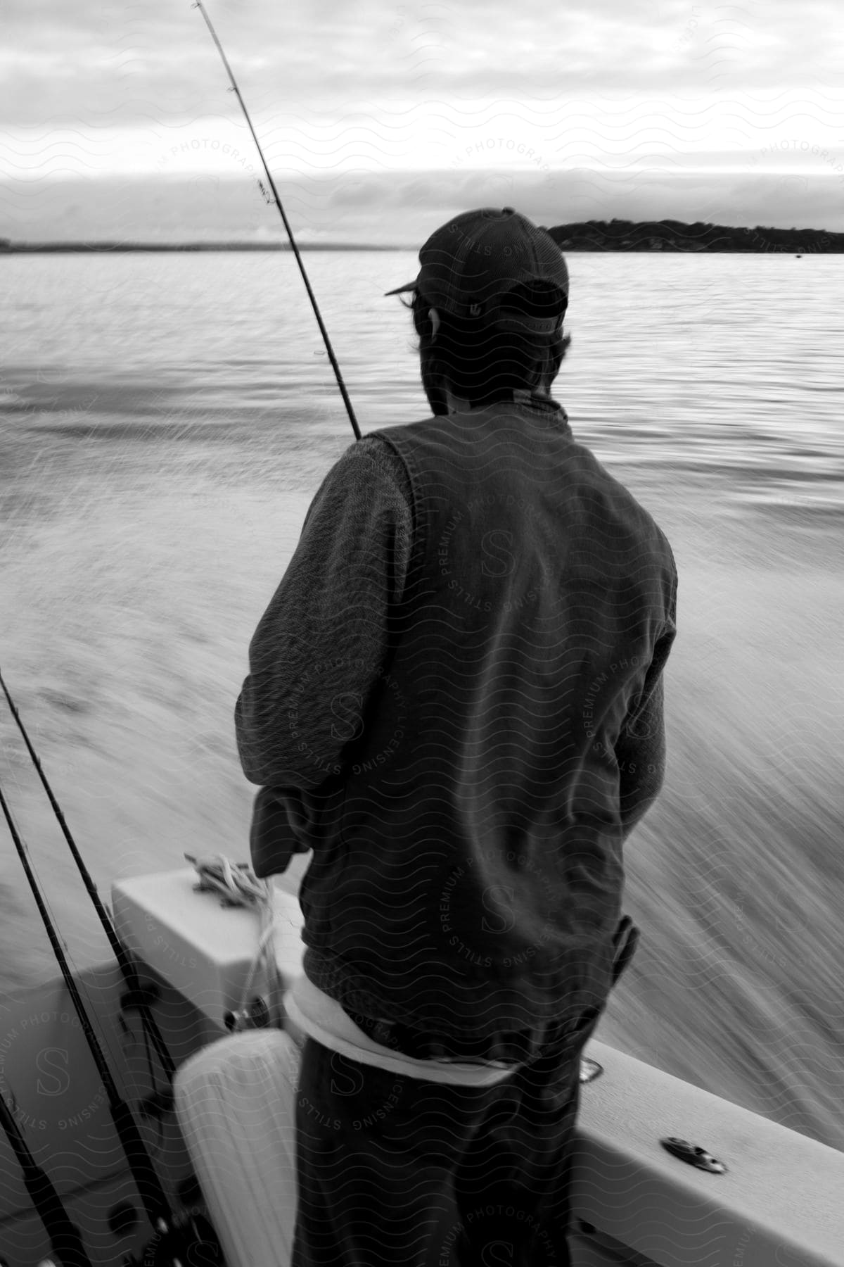 Man skillfully casts fishing line from boat in anticipation of catching a fish