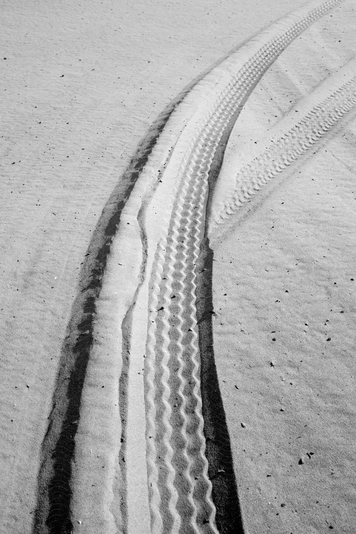 Tire tracks cutting through desert sand