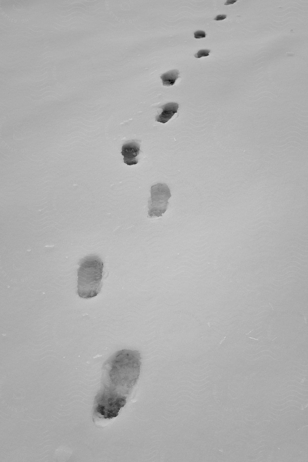Boot footprints stretch across the snow covered ground
