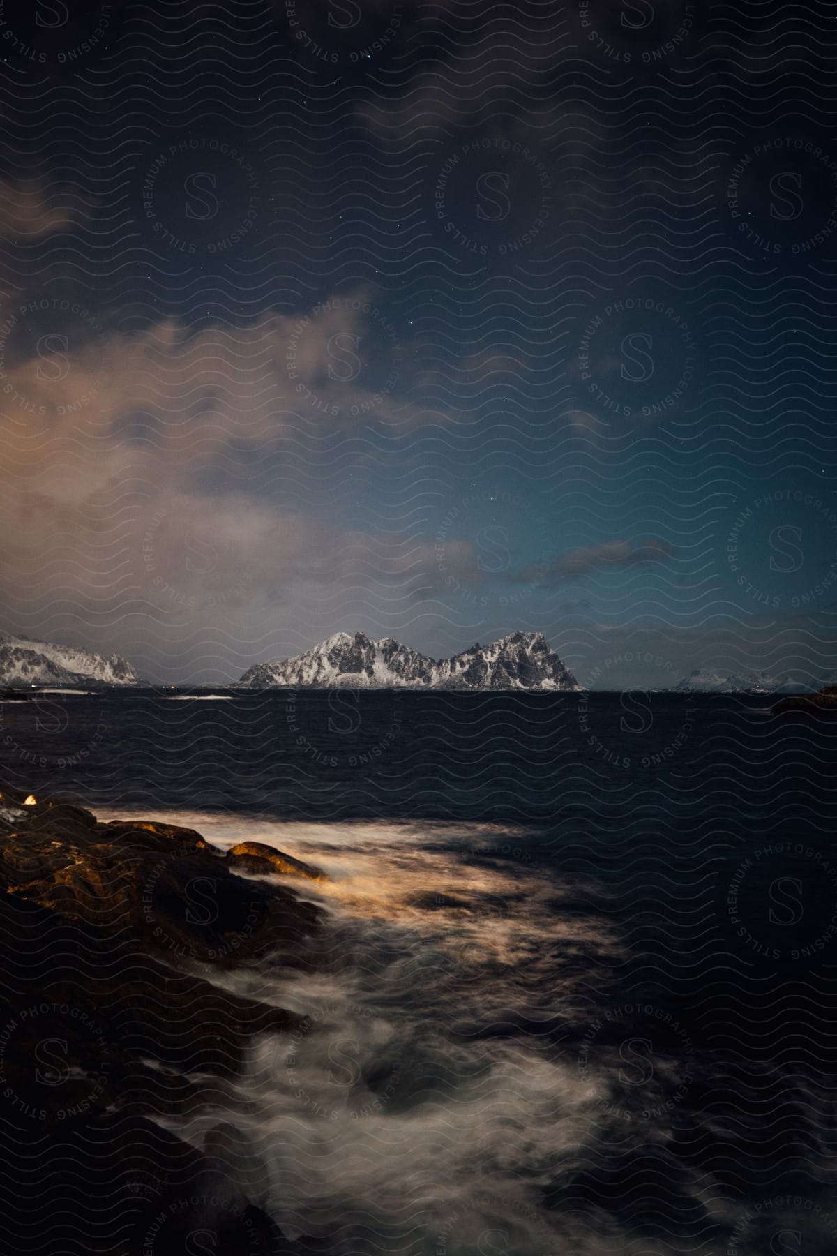 A Mountain Stands In Front Of The Sea As Dusk Approaches