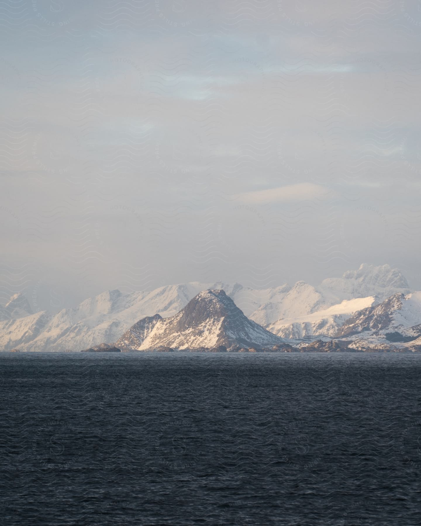 A serene winter landscape with icy mountains and a clear sky