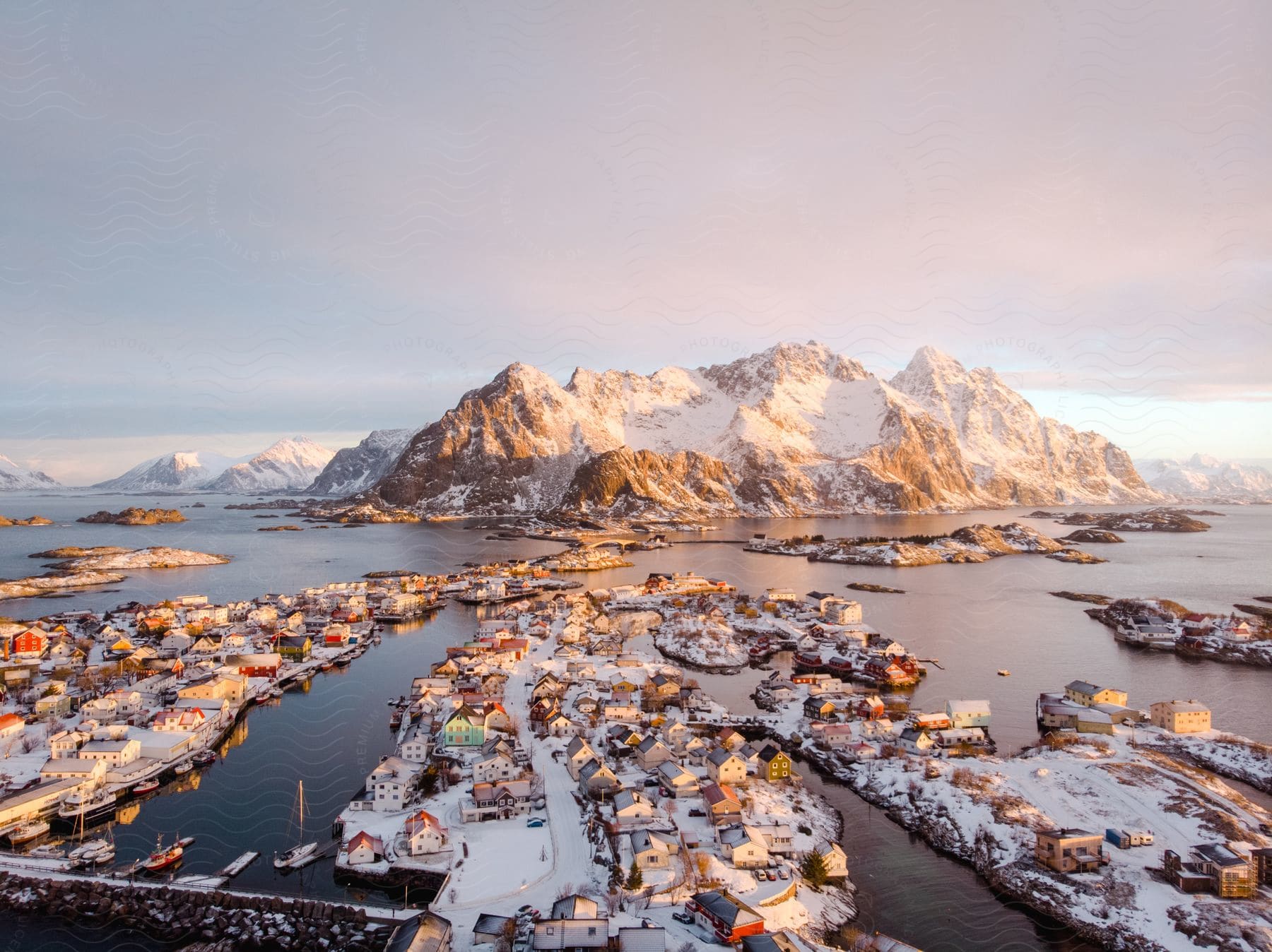 A serene winter landscape with a frozen lake snowy mountains and a city in the distance