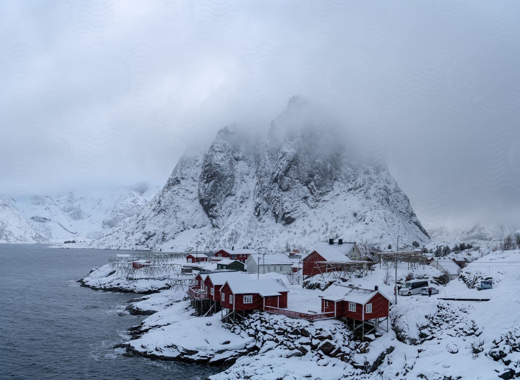 Houses near a river with a snowcovered mountain in the background