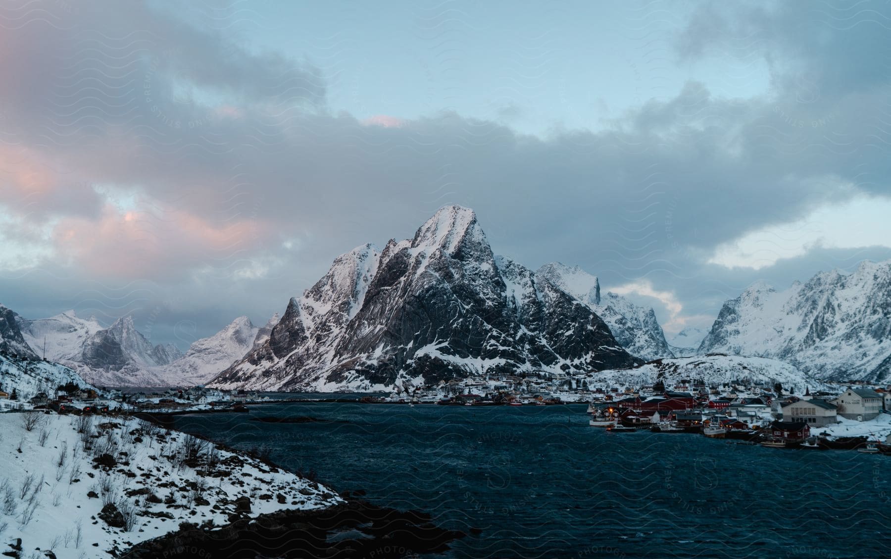 A snowy mountain landscape with a frozen watercourse