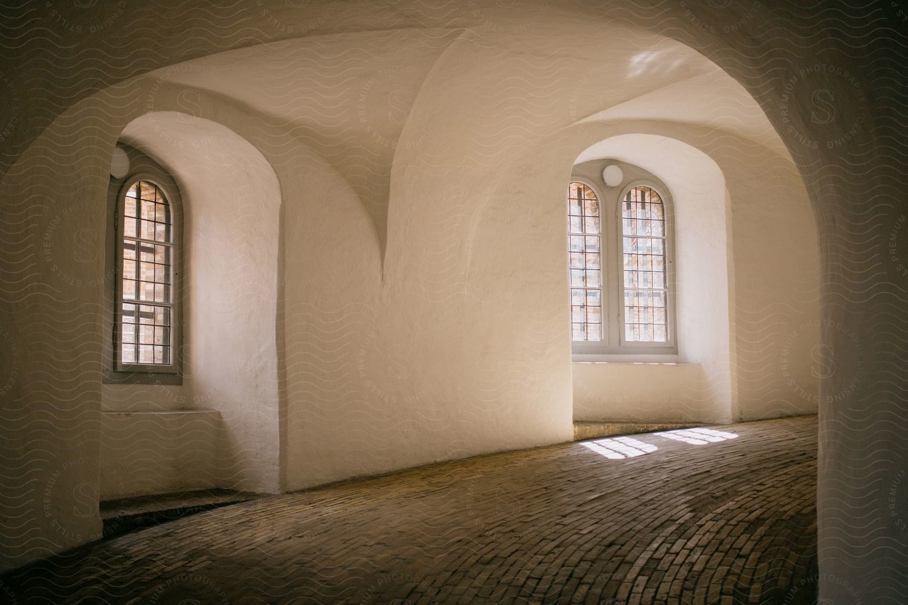 A homes hallways and windows are arched in an interior setting