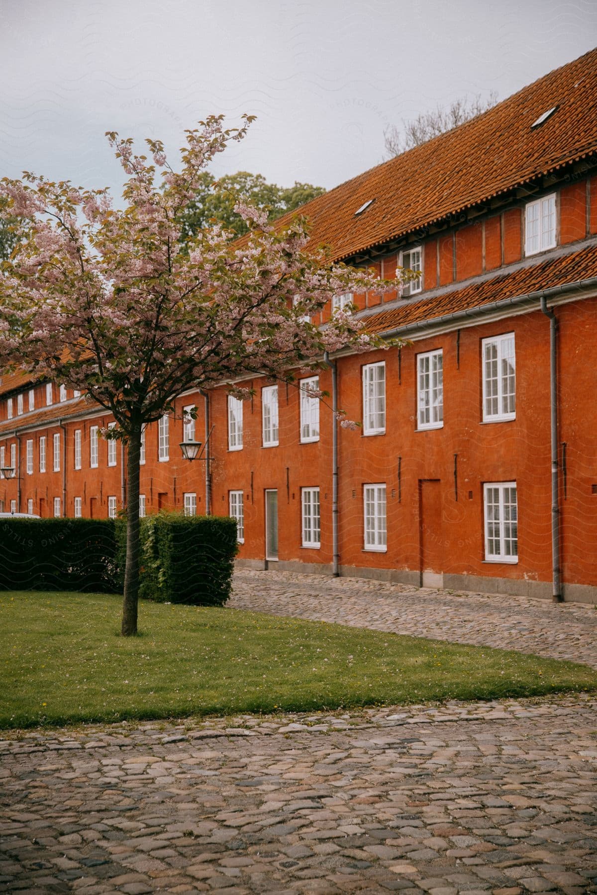 A Long Red Building Is Shown Near Some Landscaping And Walkways In Copenhagen